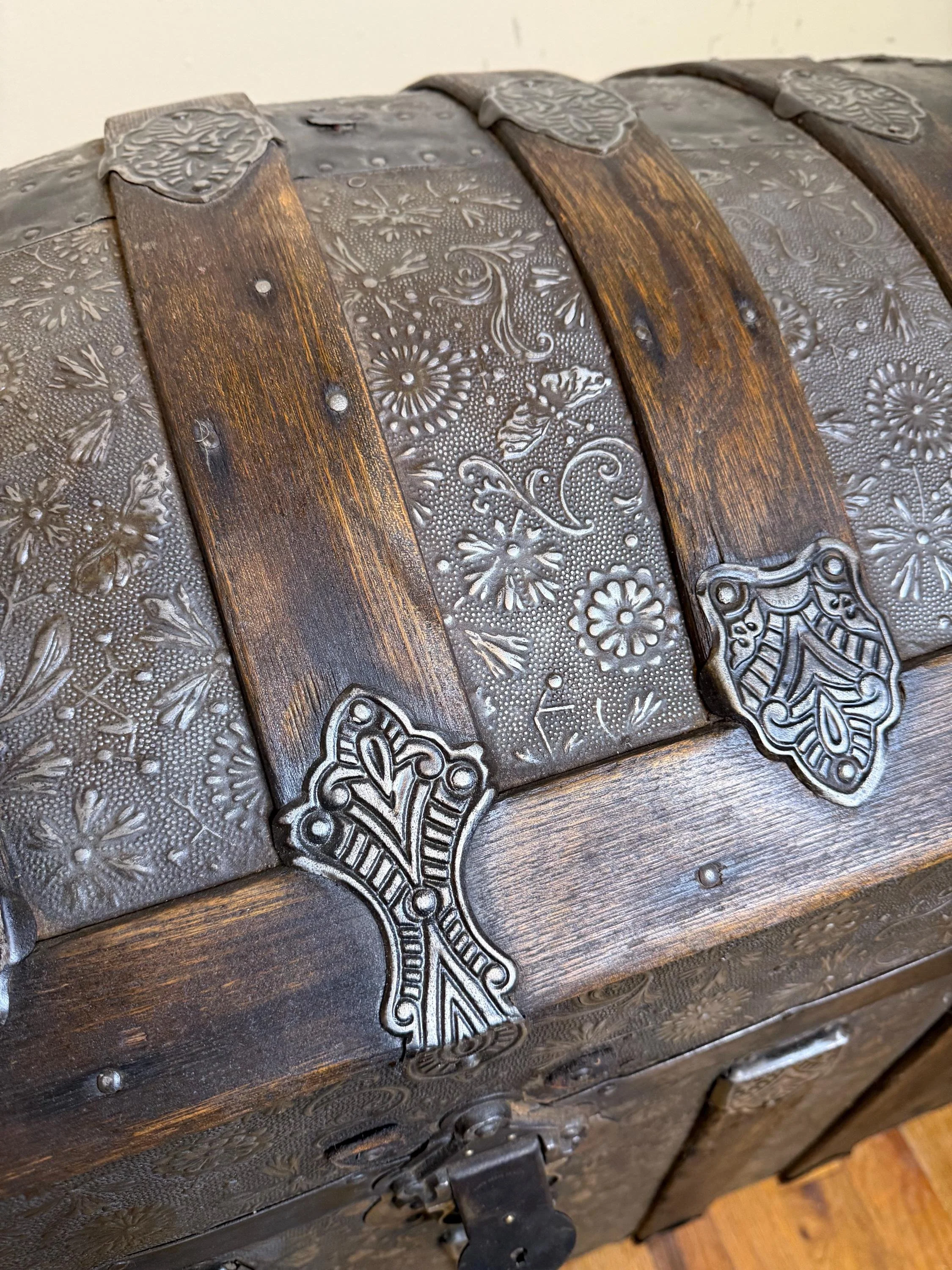 Refined walnut grain on solid oak slats of a restored Victorian floral trunk