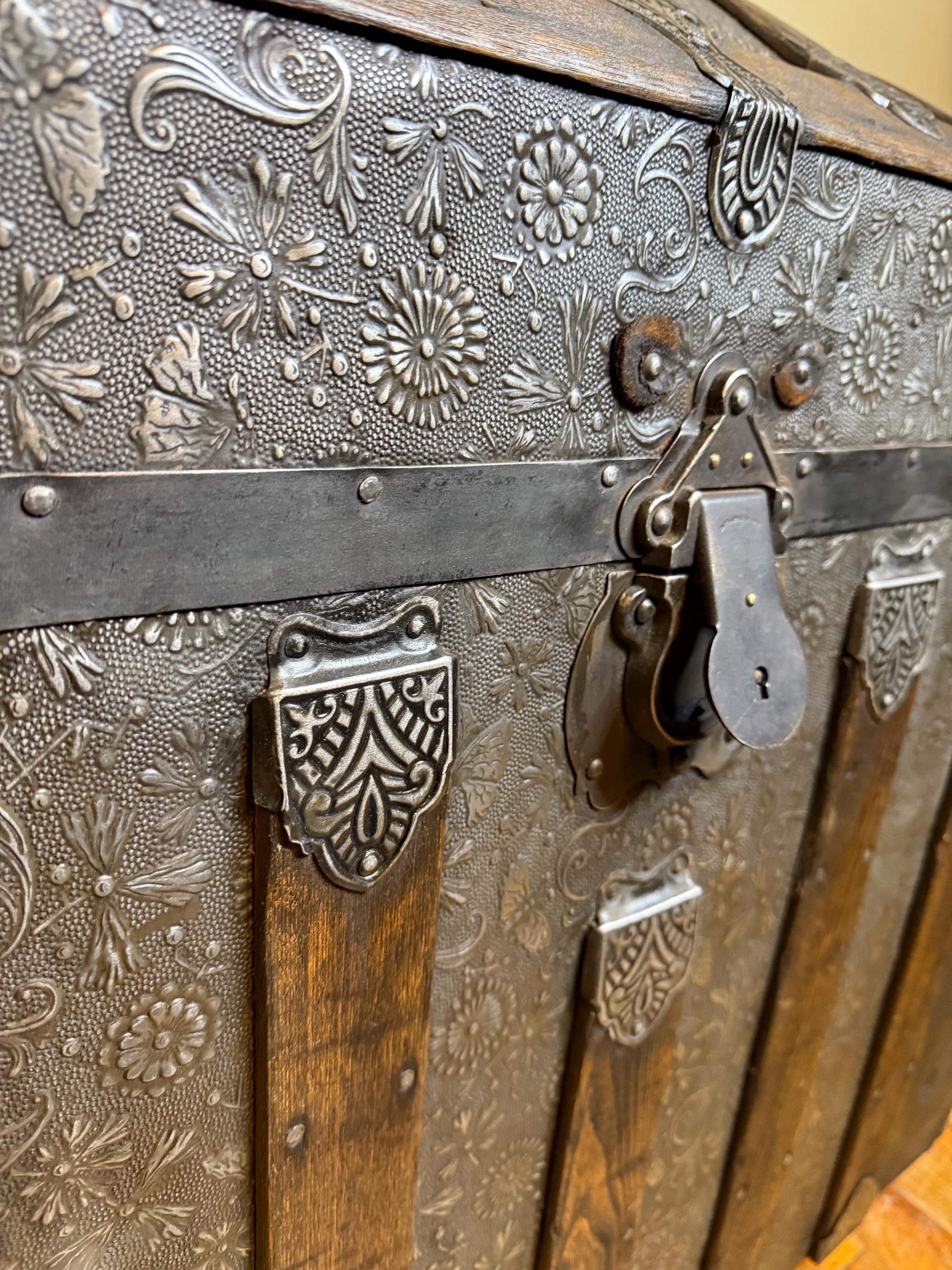 Museum-quality rare floral Saratoga trunk providing deep storage for heirlooms.