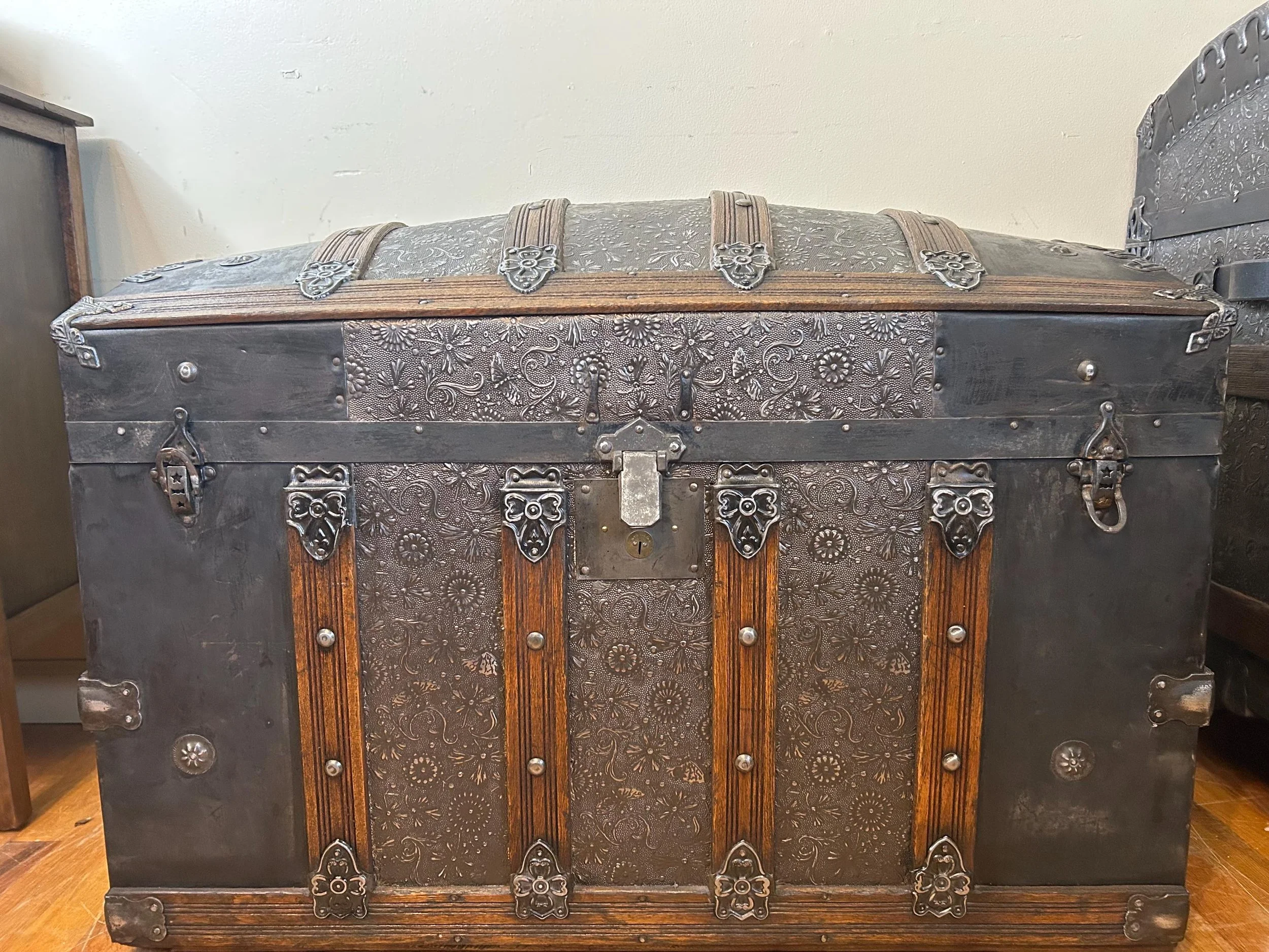 Masterfully restored large antique dome top trunk with a rare embossed tin pattern.