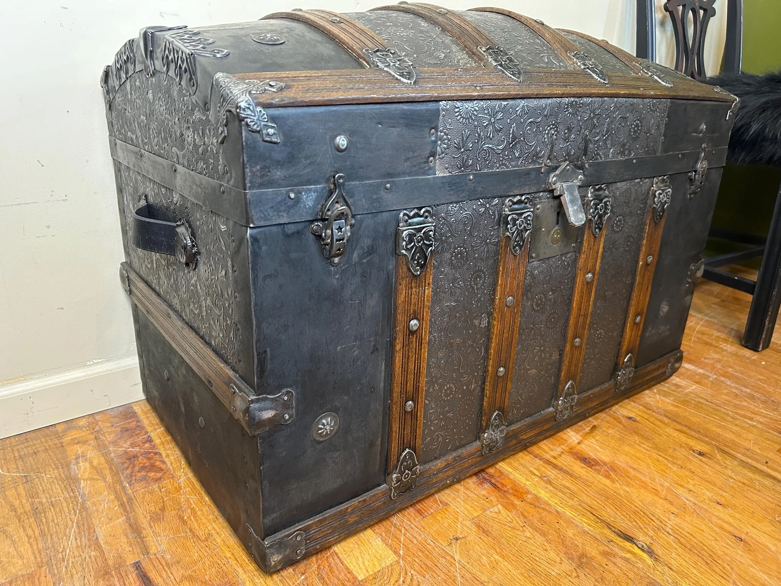 Large Victorian humpback treasure chest professionally refinished in black and brown