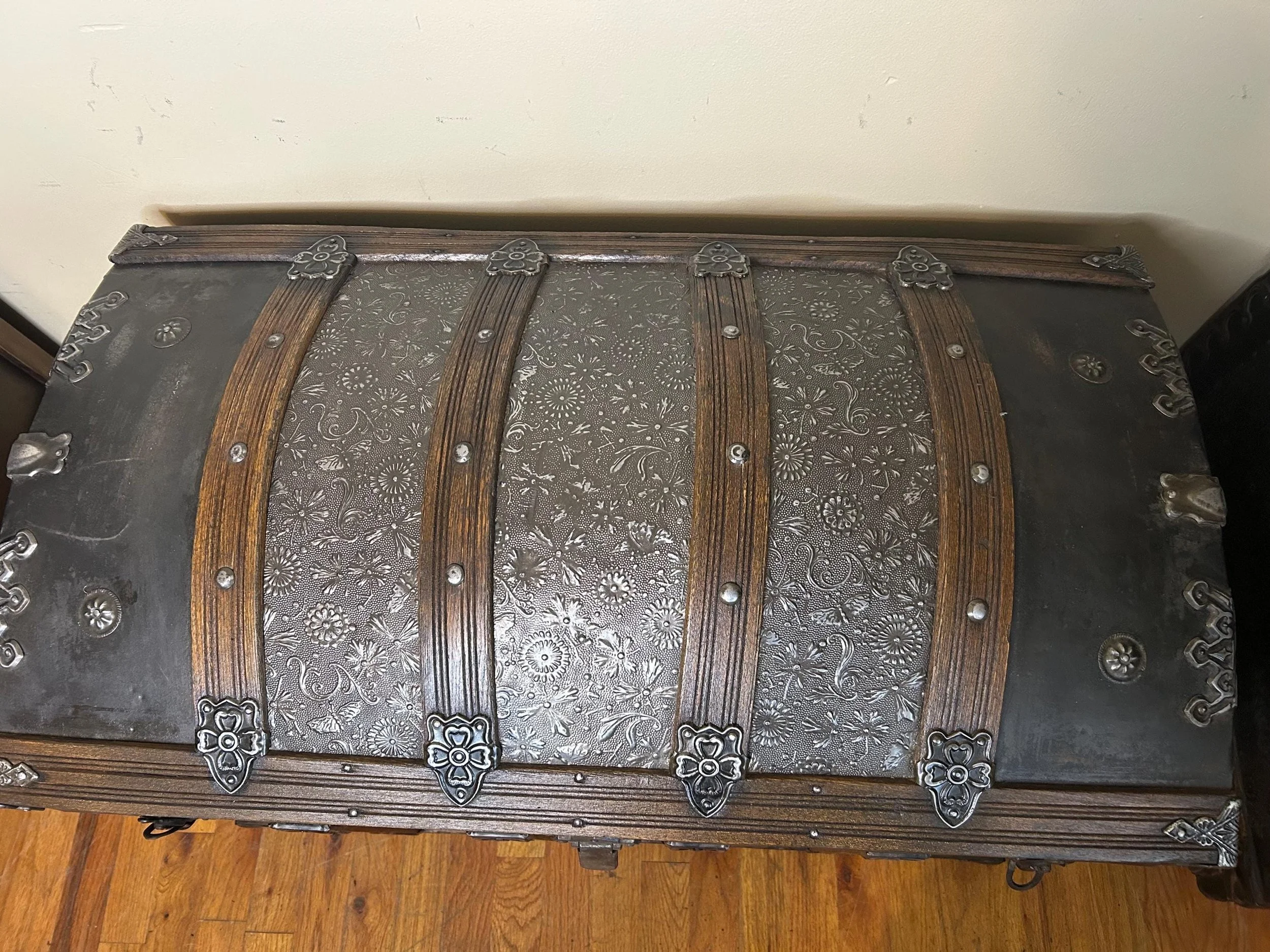 Detailed close-up of the rare architectural relief pattern on an 1800s embossed tin trunk.