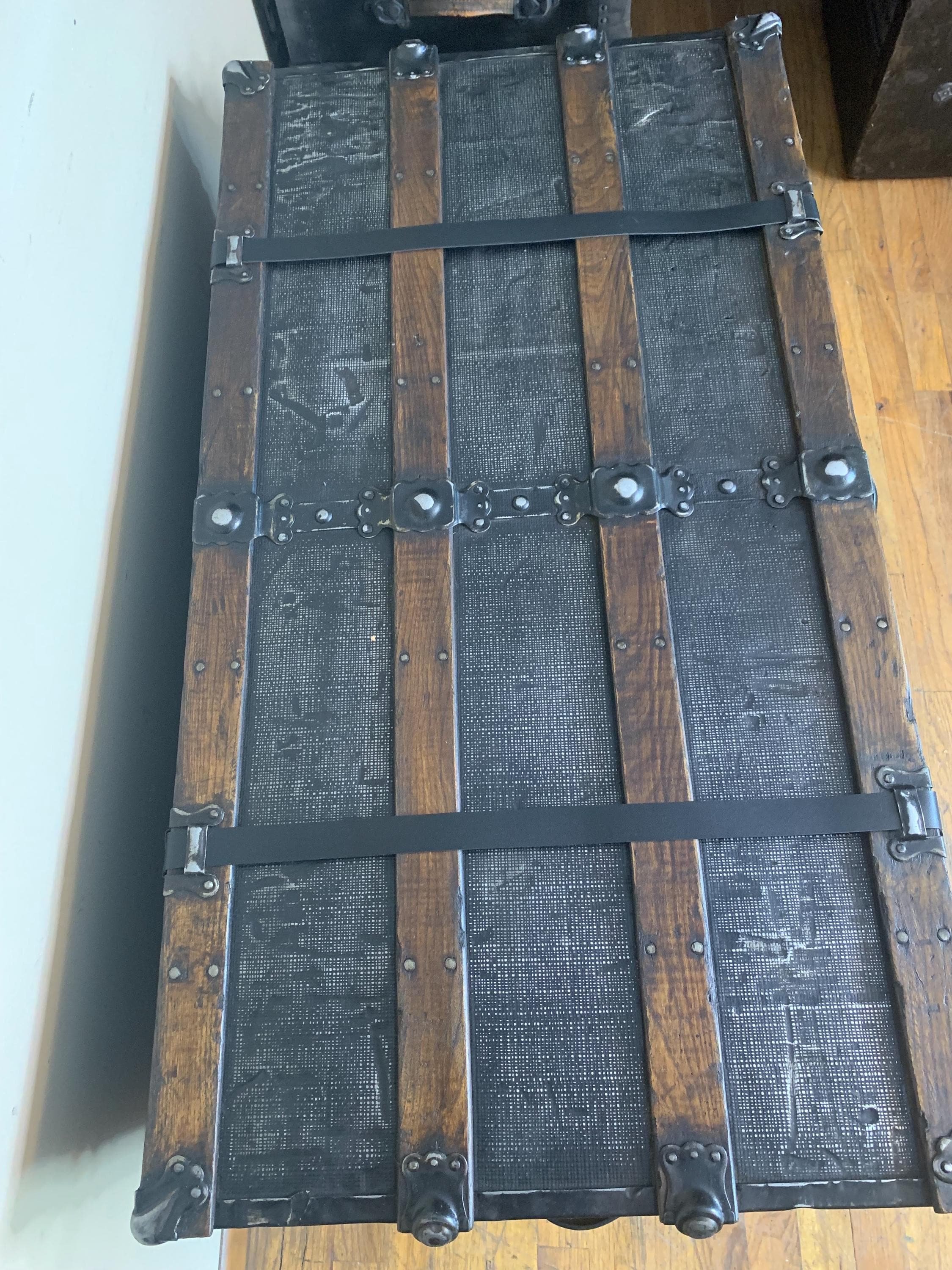 Solid oak wood slats restored in a rich walnut finish on a huge black chest.