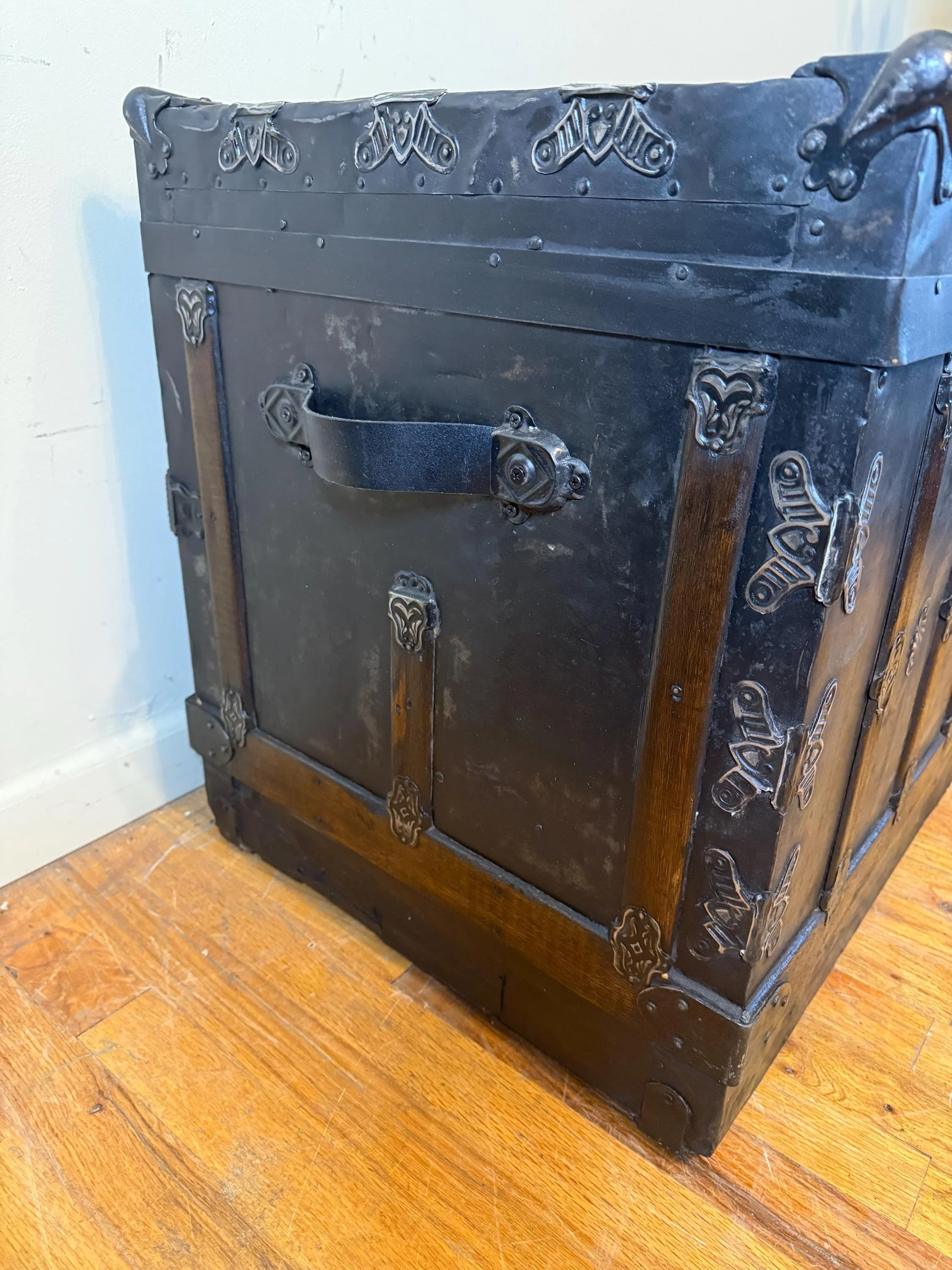 Side view highlighting the massive scale of this 19th-century travel chest