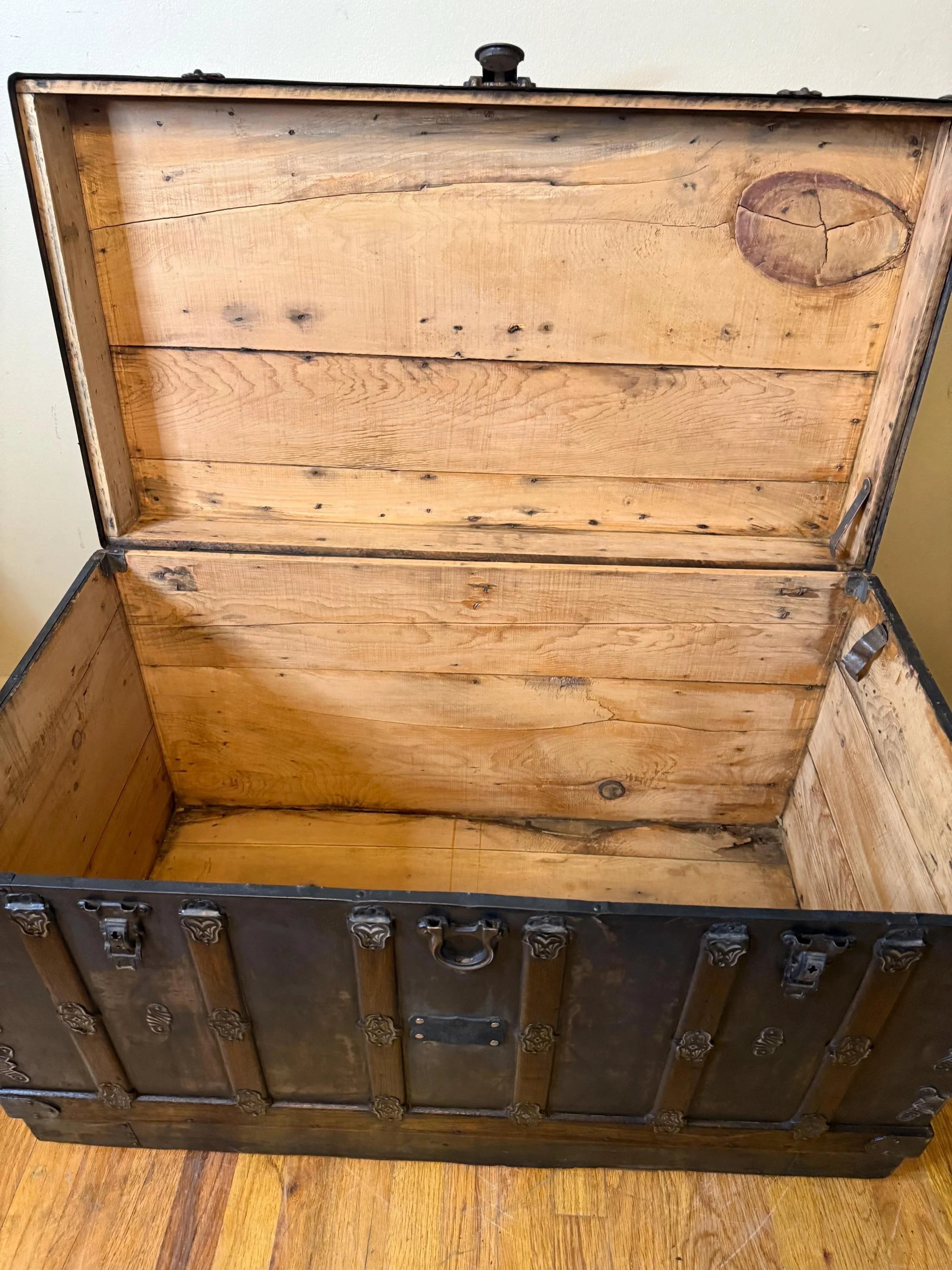 Clean, stripped and sanded wood interior of an extra-large storage chest.