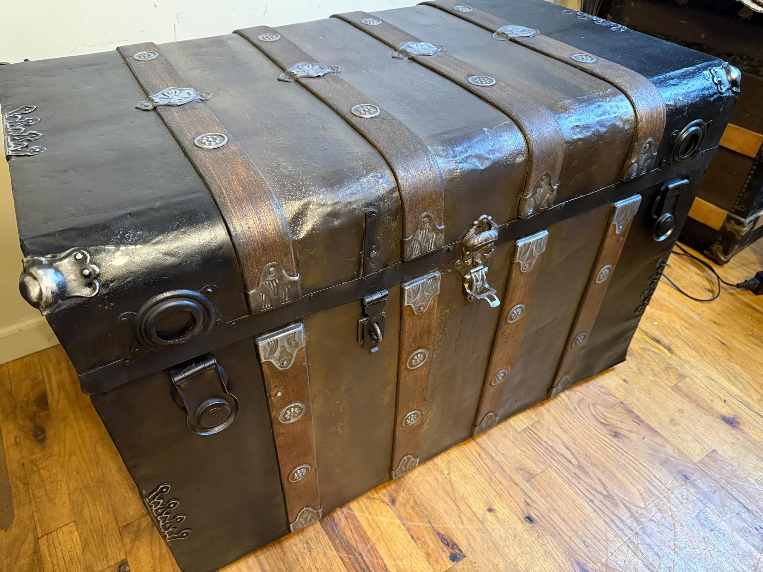 Vintage luggage chest with ornate hardware and double hasps