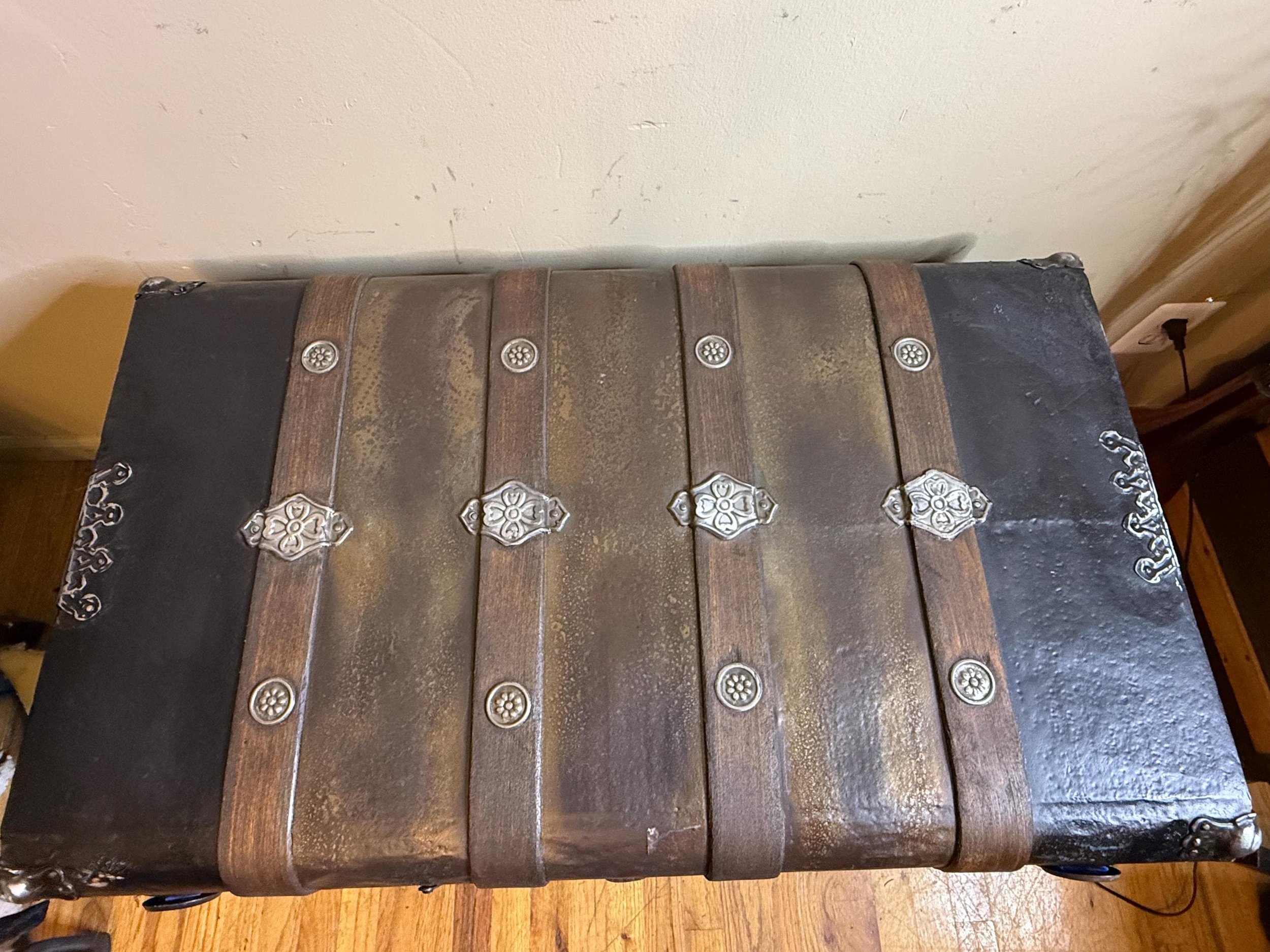 Vintage luggage chest with ornate hardware and double hasps