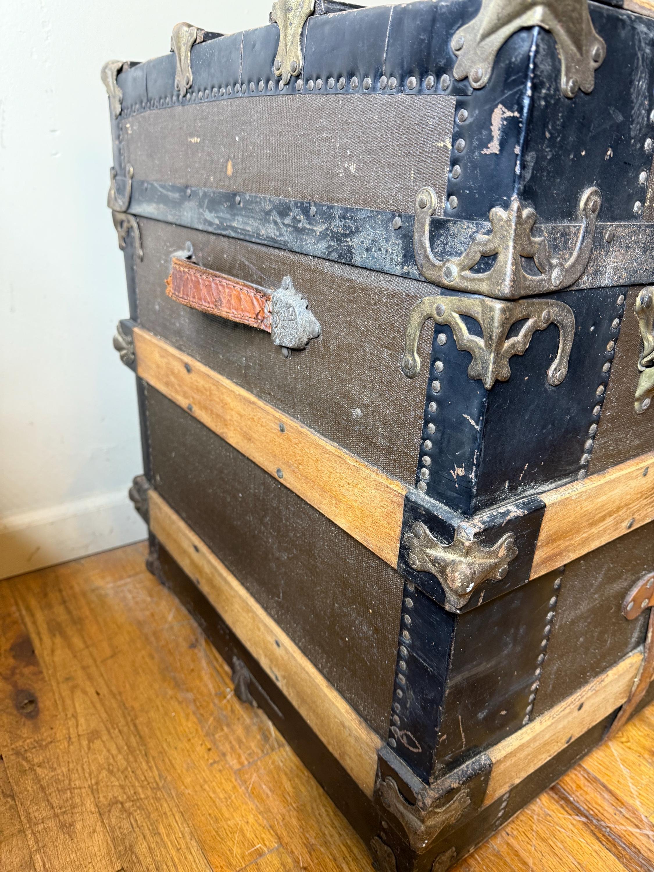 Side profile of a 34-inch wide flat top storage trunk highlighting its historical character.