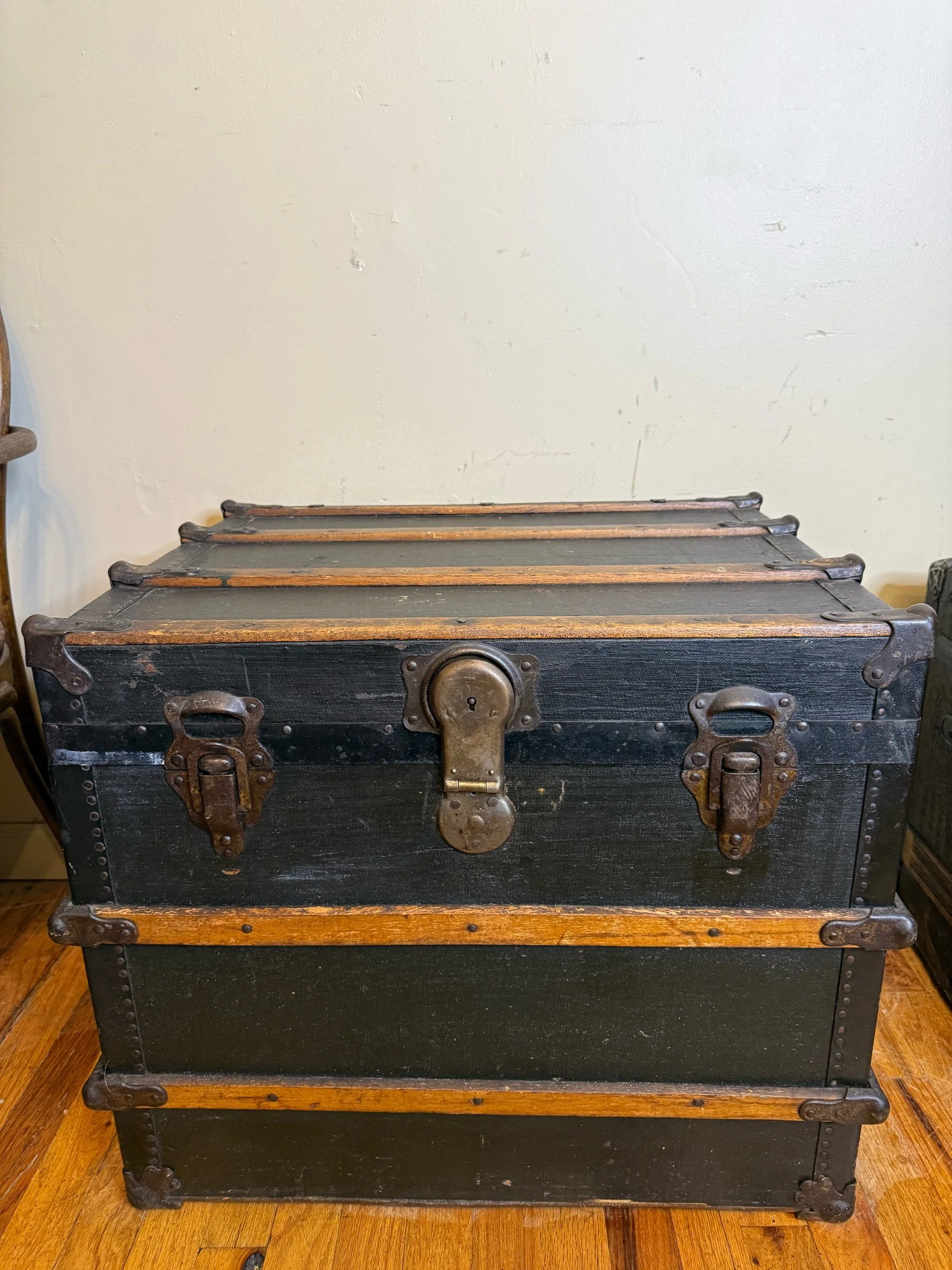 Vintage black travel trunk coffee table front view