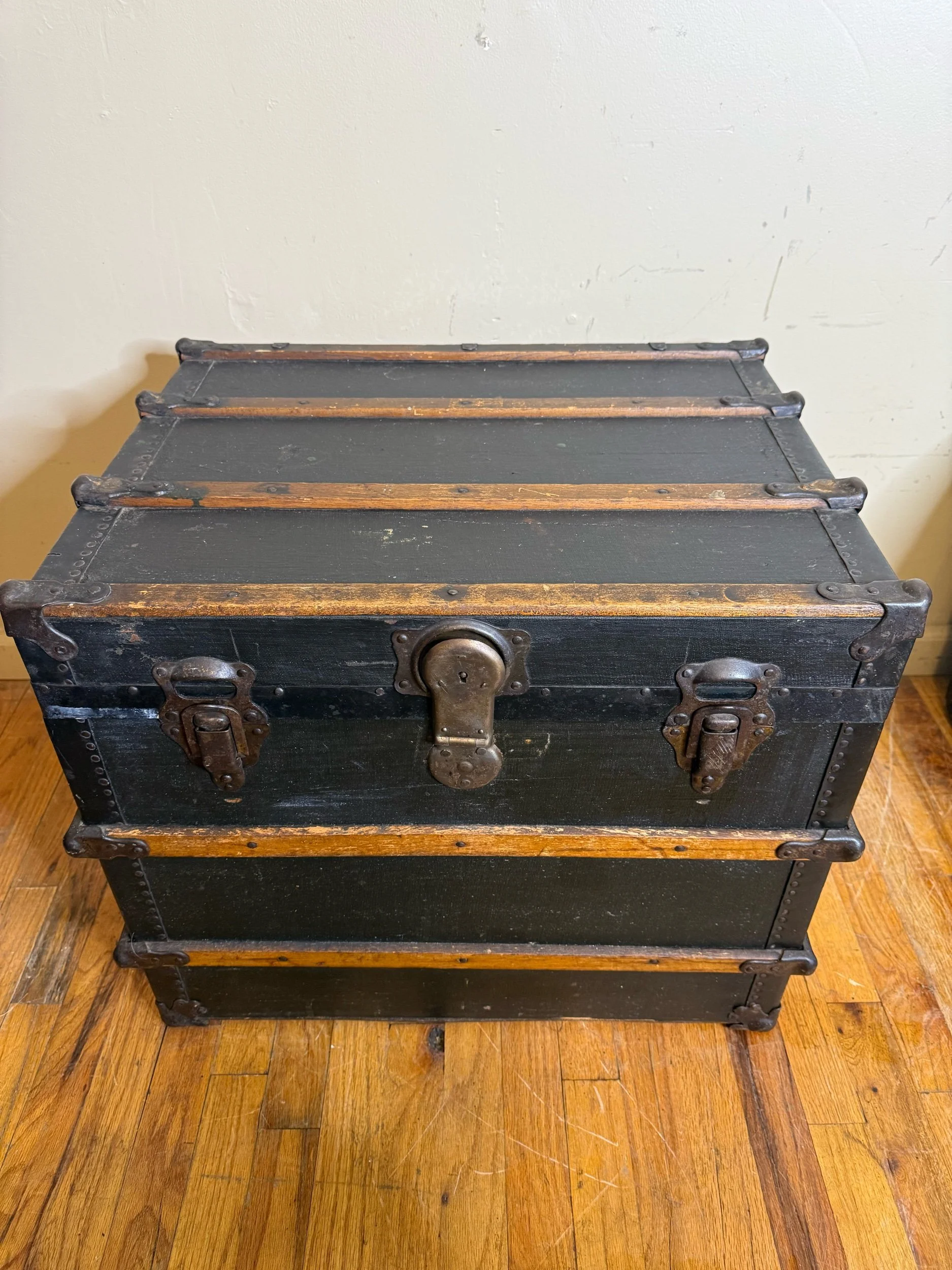 Antique storage chest with aged canvas and brass trim