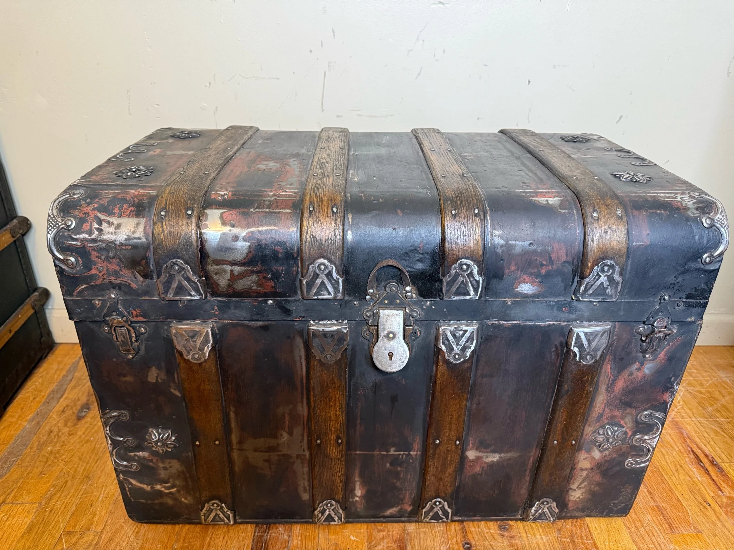 Antique monitor top steamer trunk with waterfall front and refinished tin exterior
