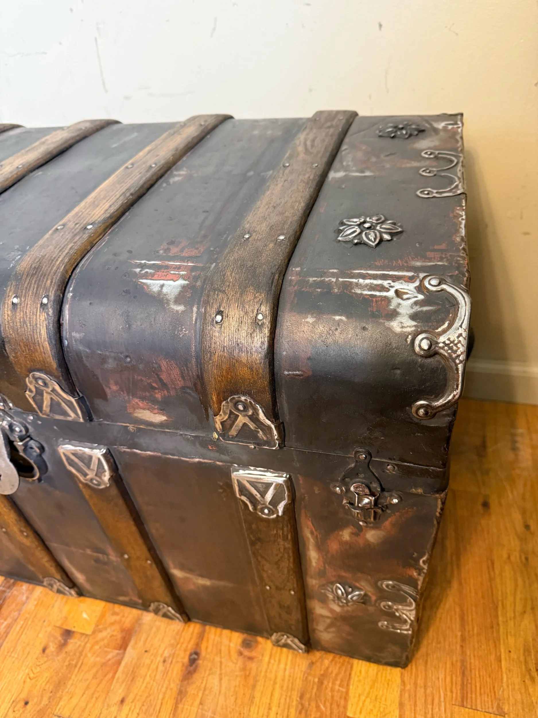 Antique monitor top trunk showing original smooth tin cladding