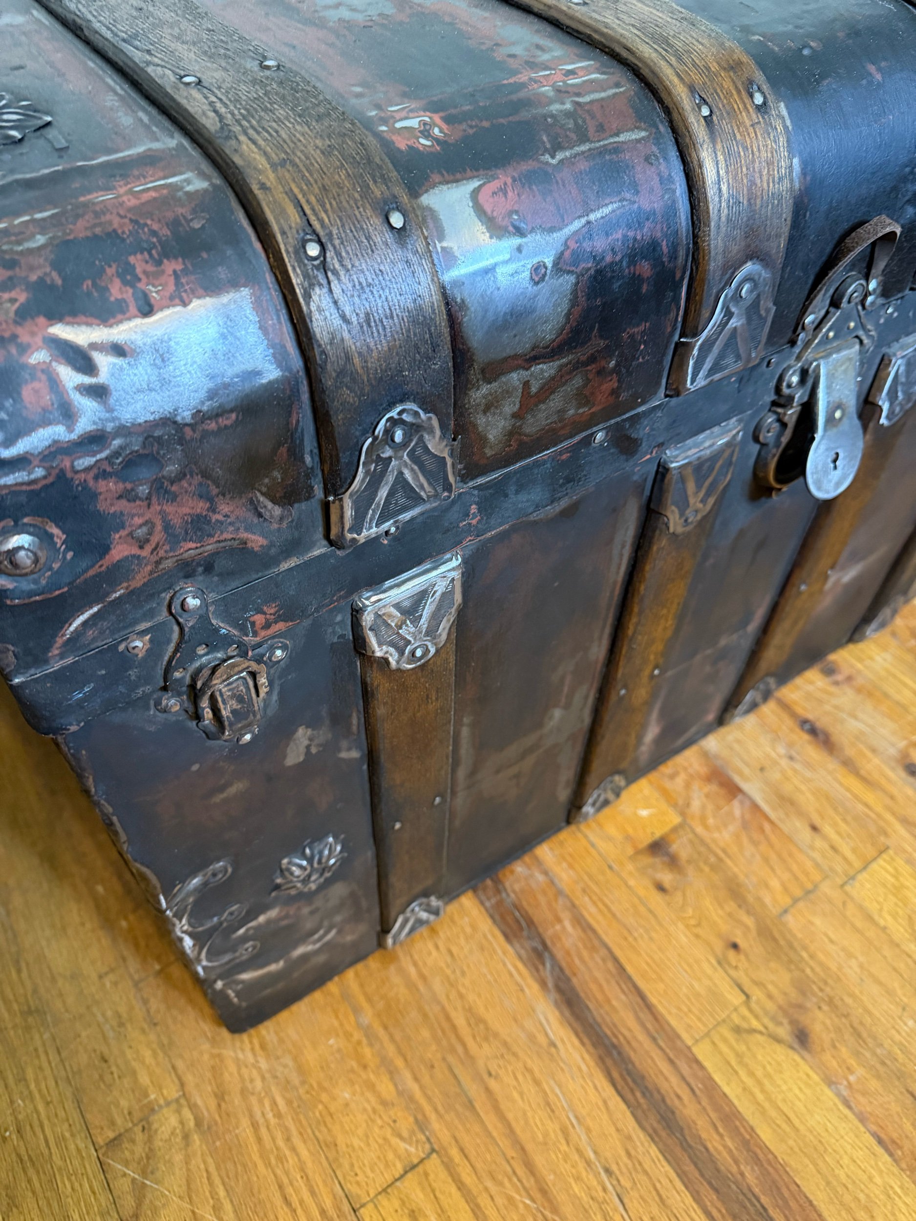 Waterfall front antique trunk with industrial inspired refinished finish