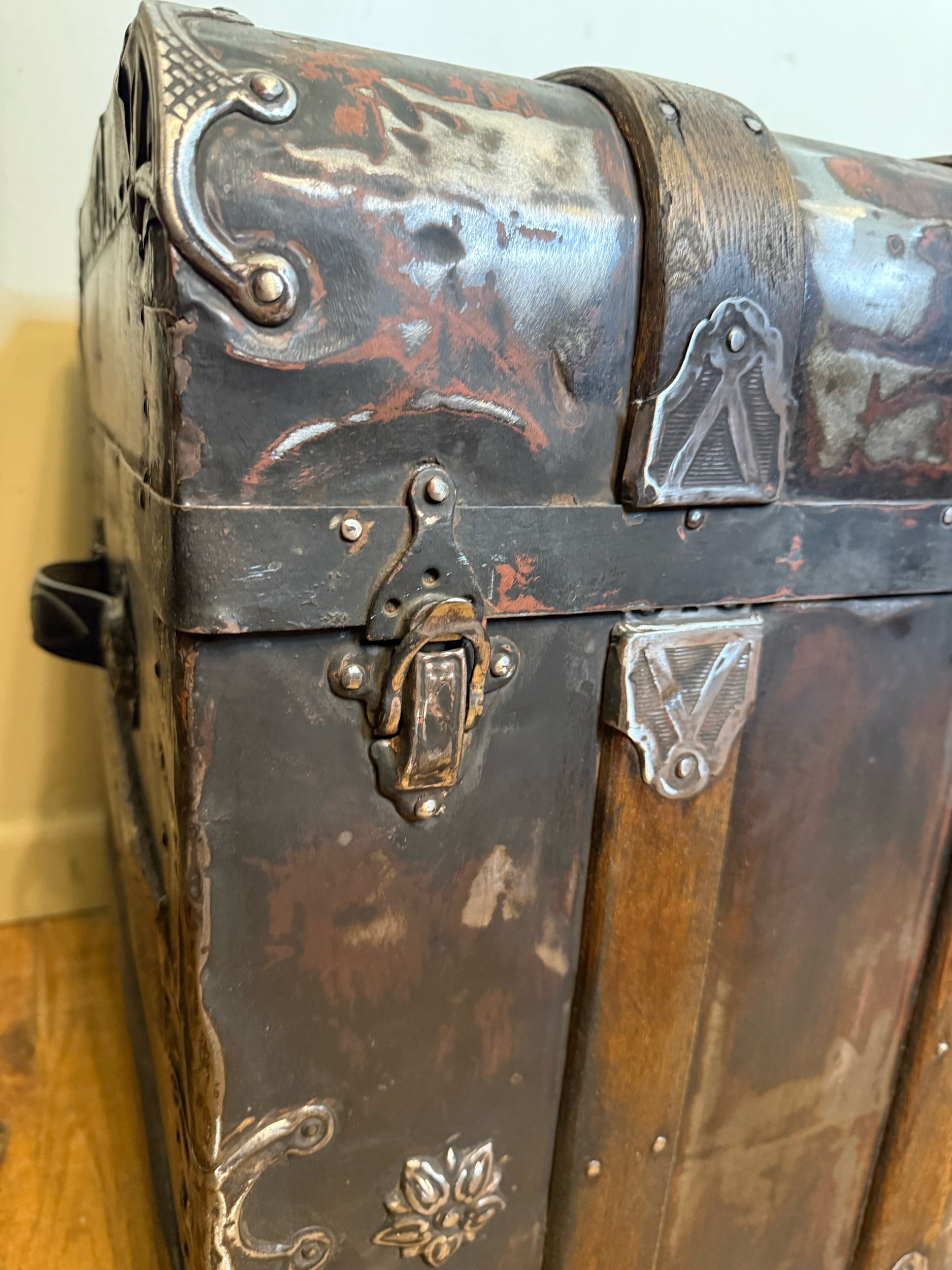 Dark academia decor featuring antique monitor top steamer trunk