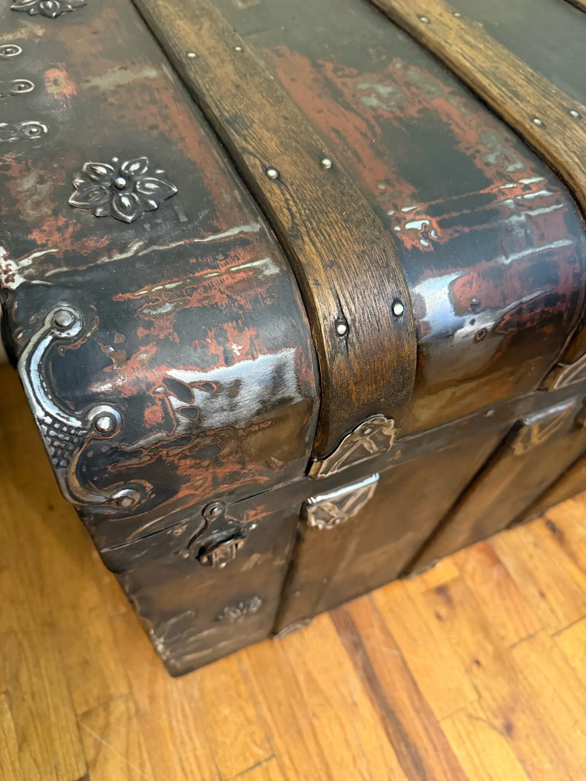 Close-up of restored hardware on antique monitor top trunk