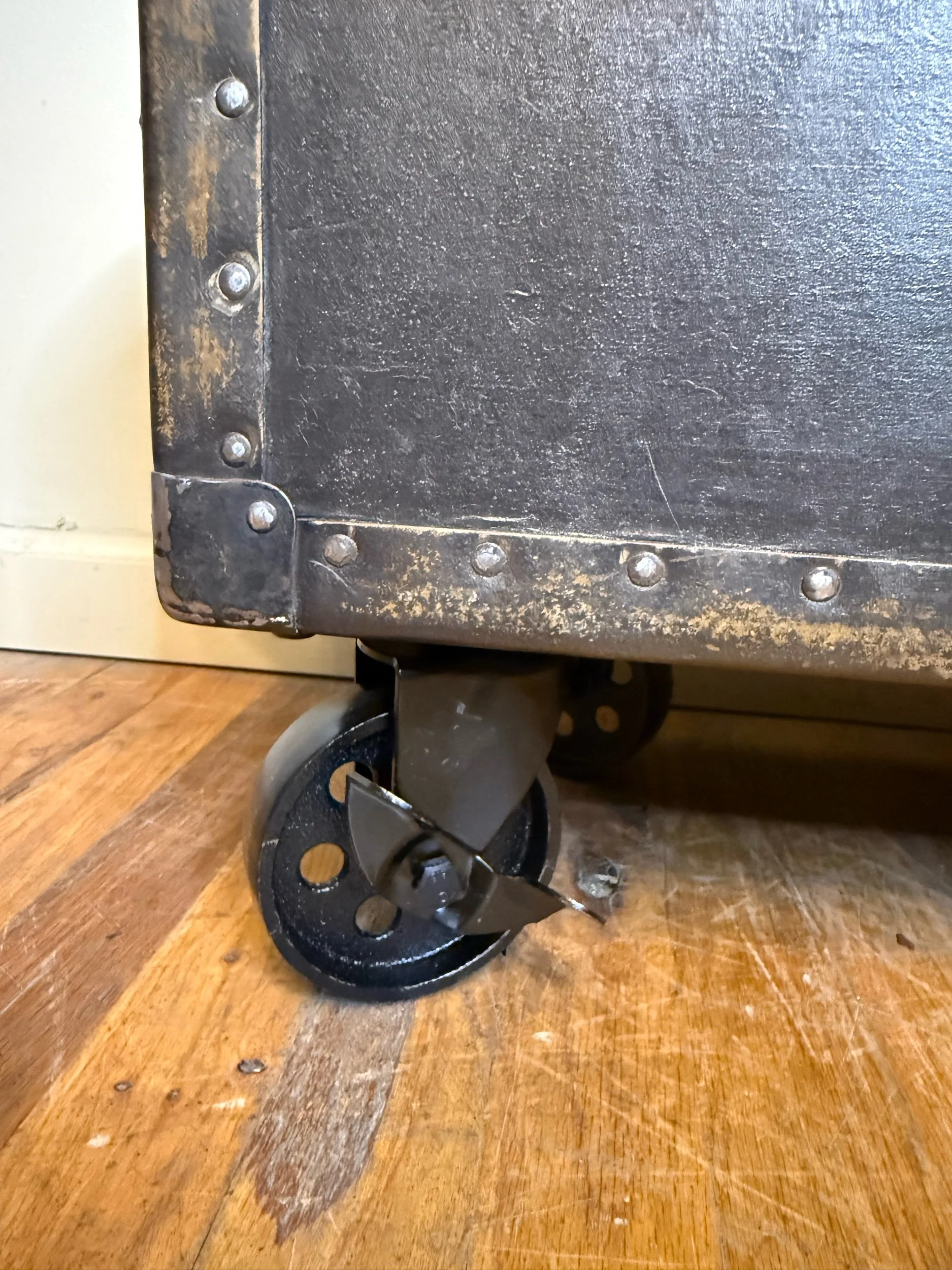 Antique storage trunk on steel swivel locking casters