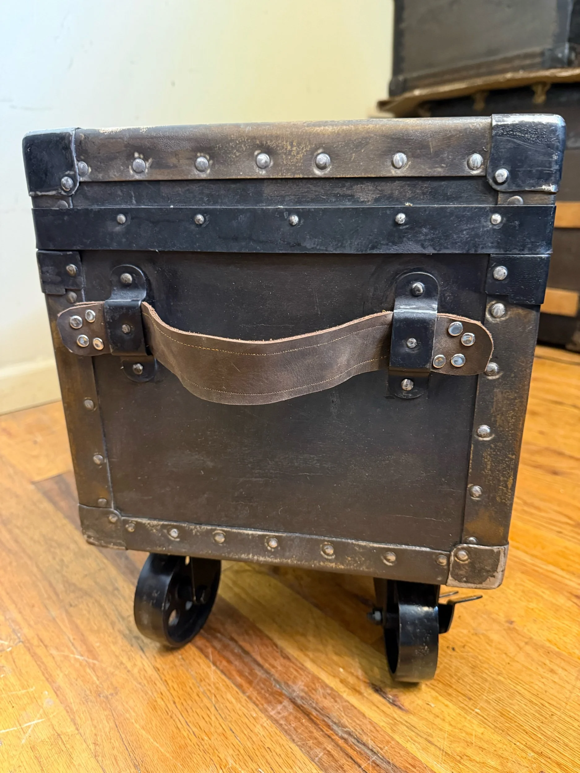 Custom brown leather handle on restored antique trunk