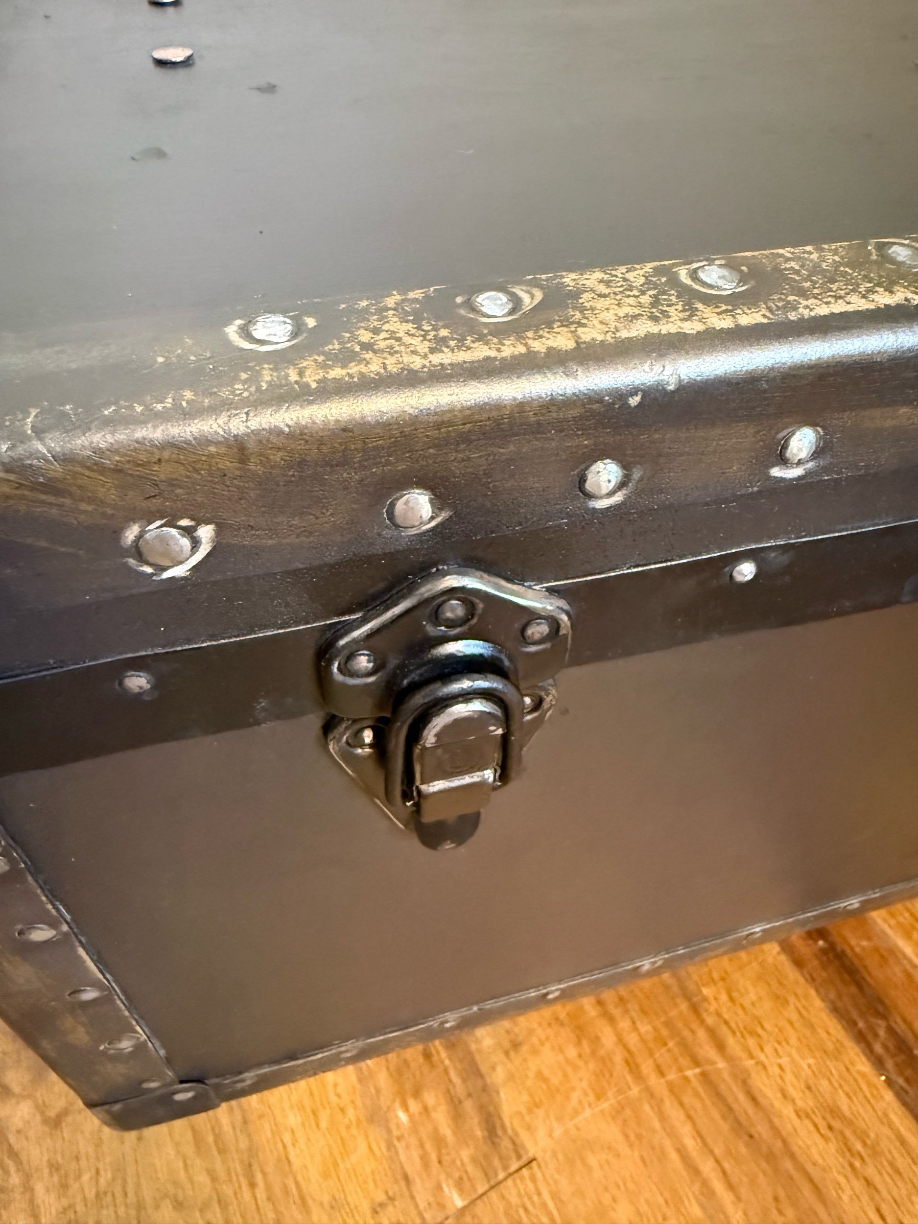Close up of antique trunk hardware and original bright tacks