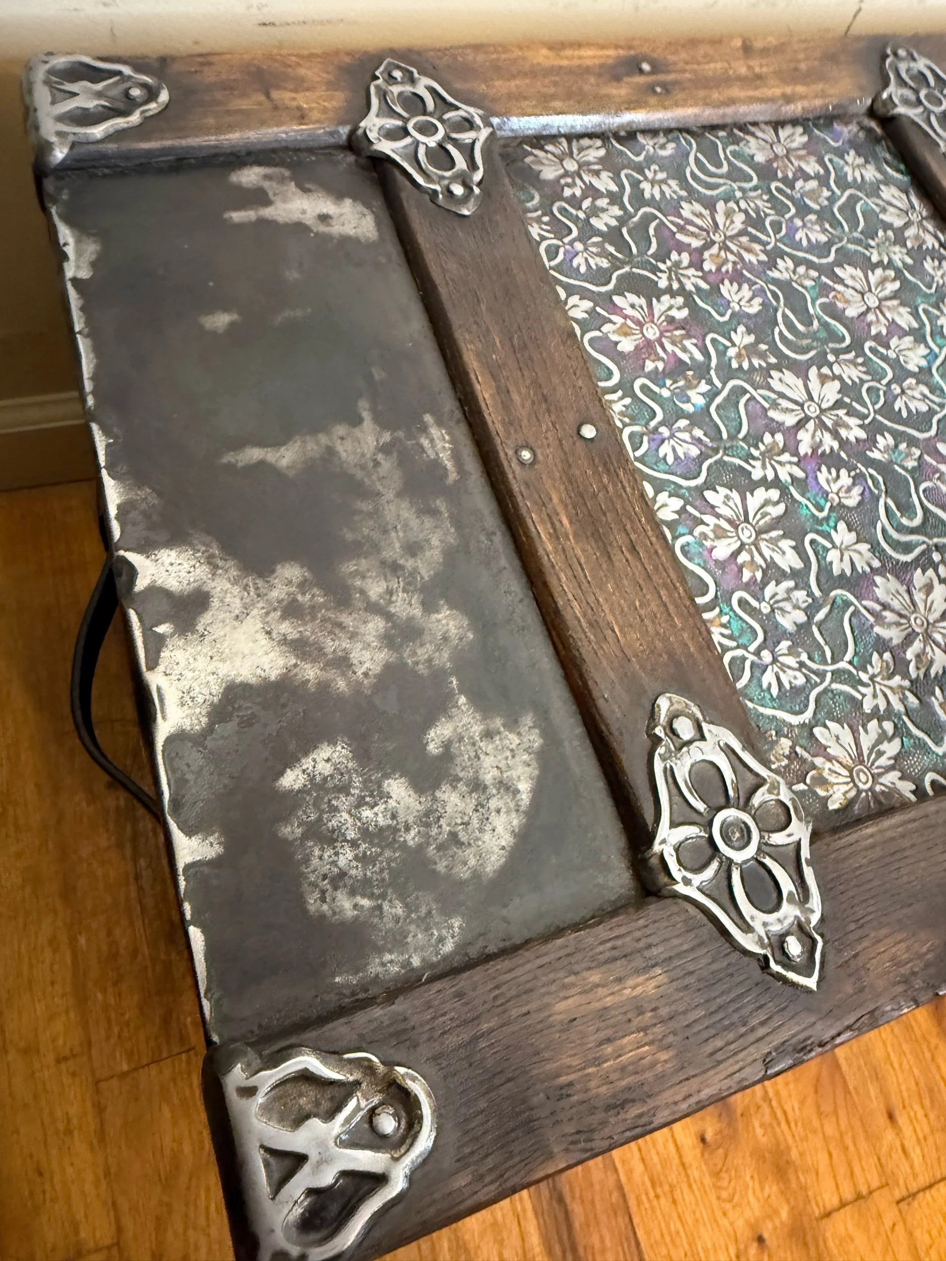 Close-up of rare embossed tin pattern on antique steamer trunk