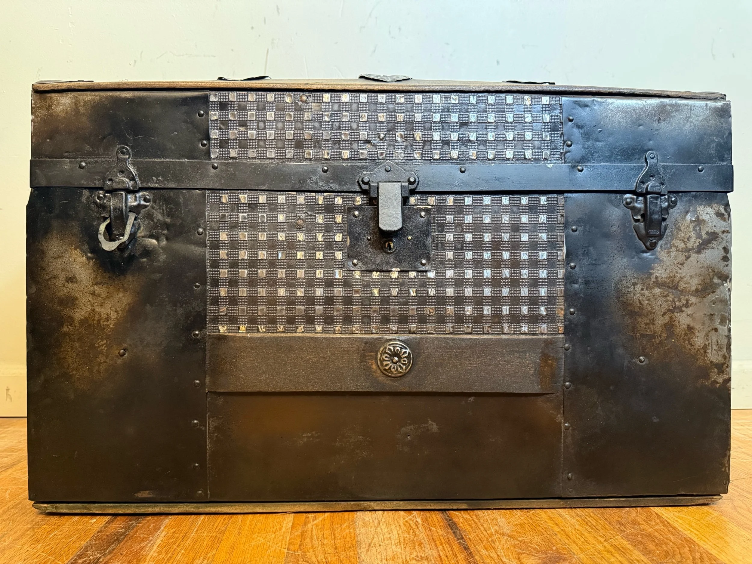 Refinished embossed tin antique trunk in deep brown and aged black