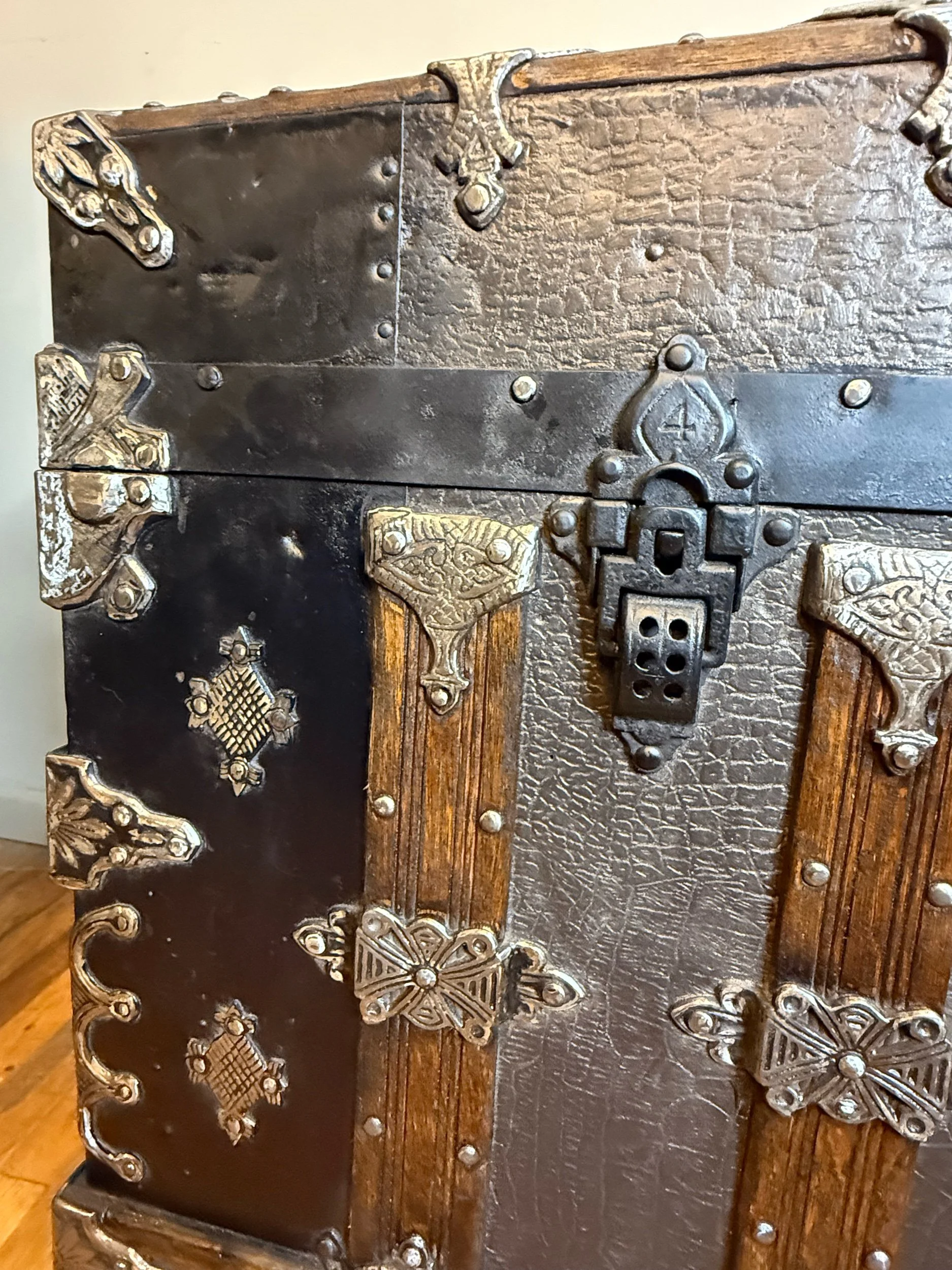 Close up of crocodile pattern embossed tin antique trunk