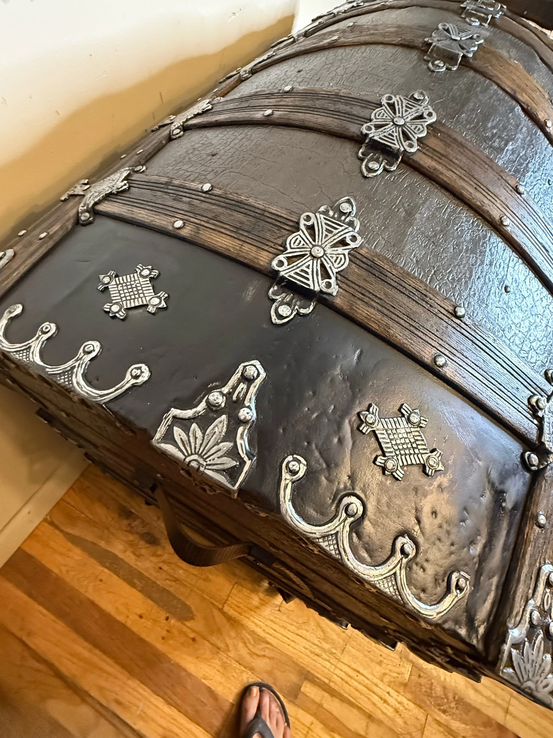 Restored antique steamer trunk with buffed black metal hardware