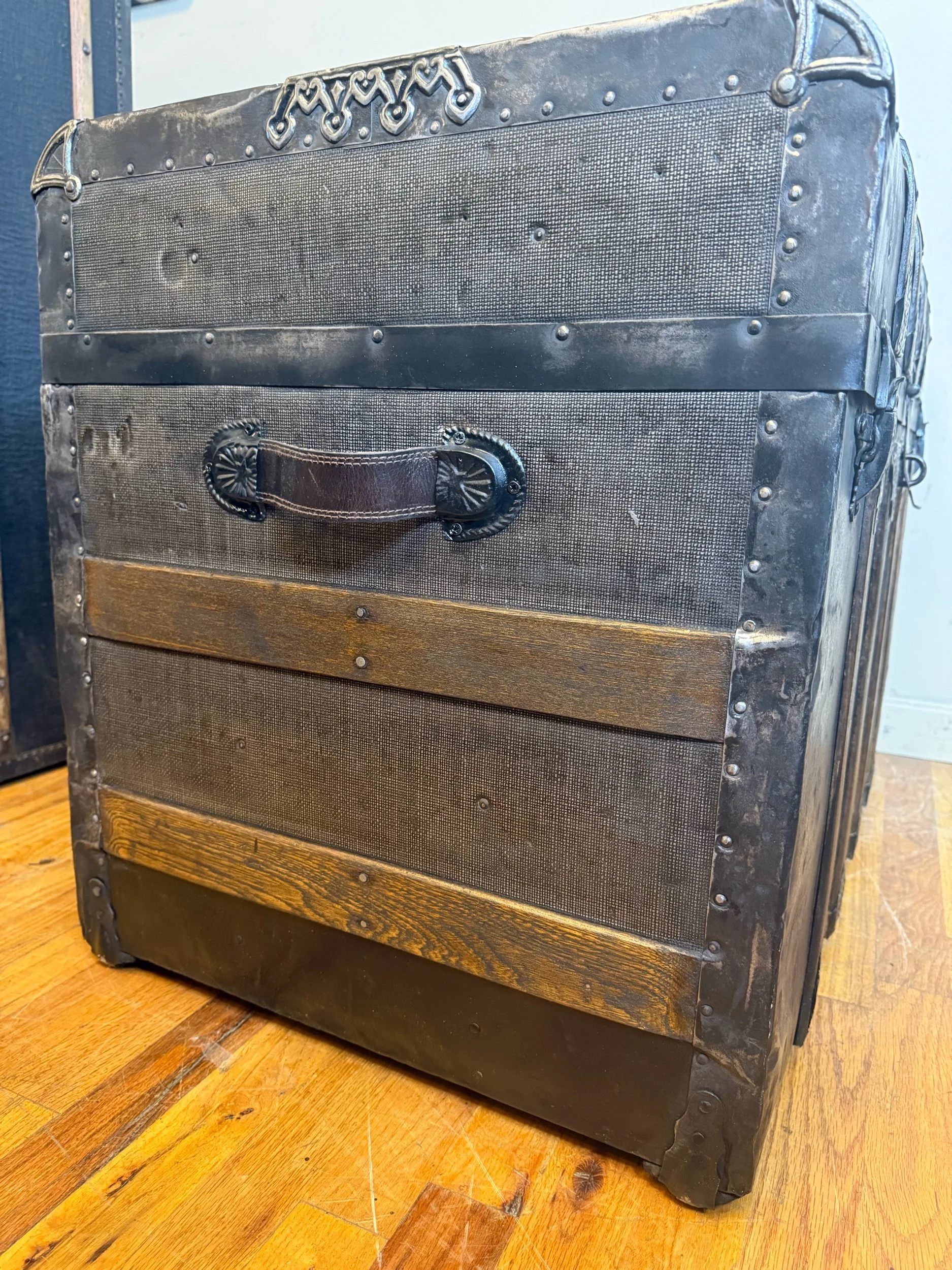 Custom leather handle on refinished antique travel trunk