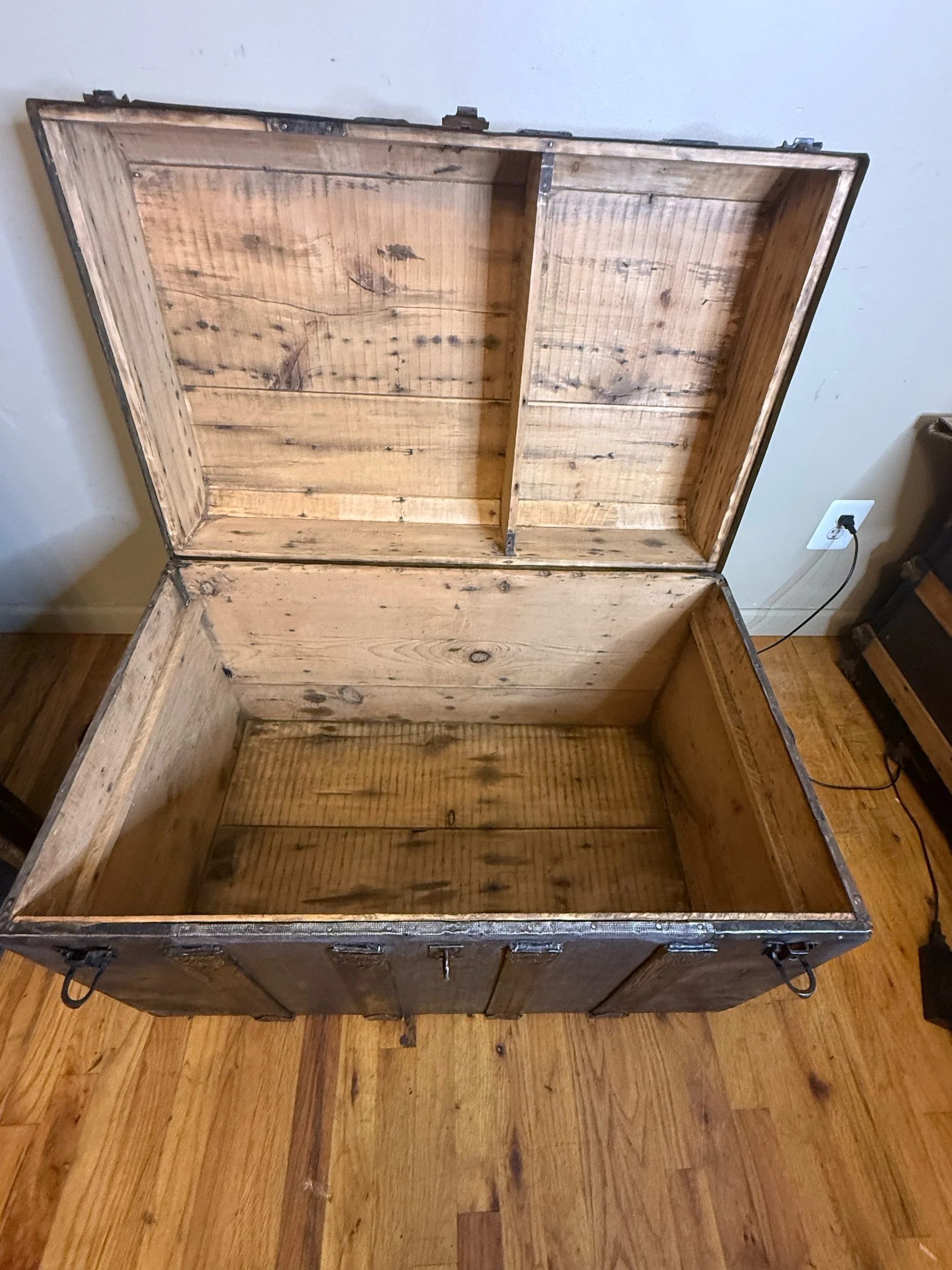 Clean sanded wood interior of antique steamer trunk