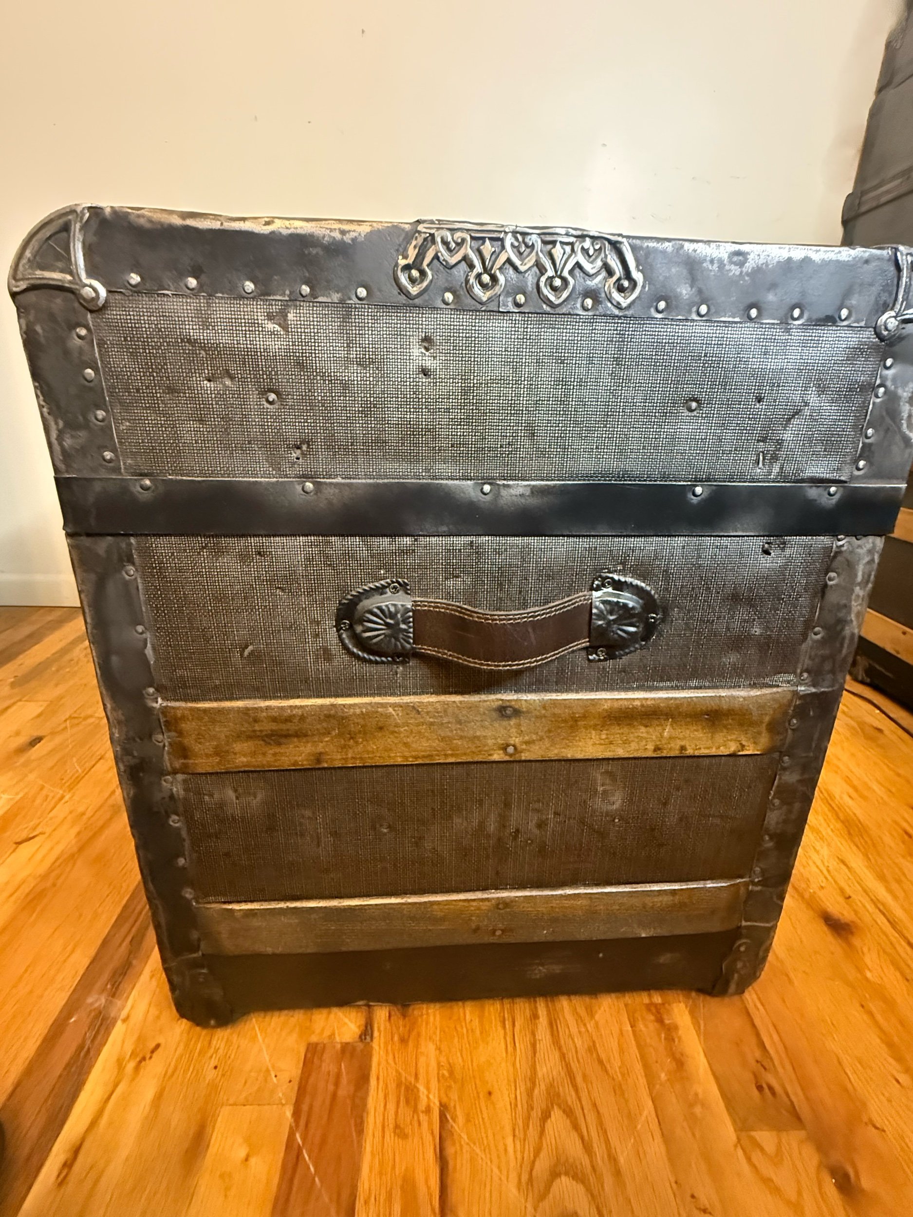 Textured tin antique trunk coffee table with waterfall front