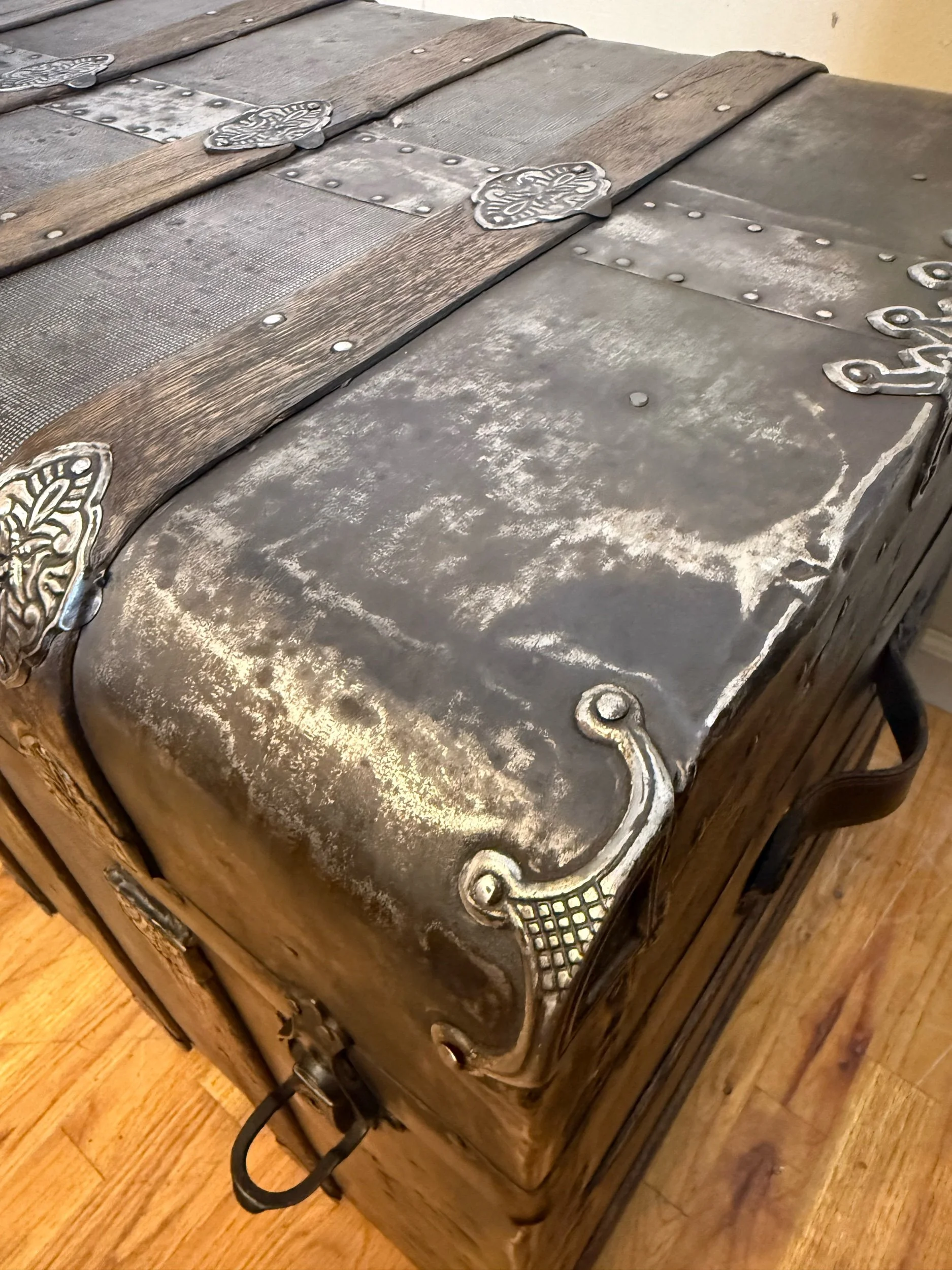 Ornate hardware detail on antique Victorian steamer trunk