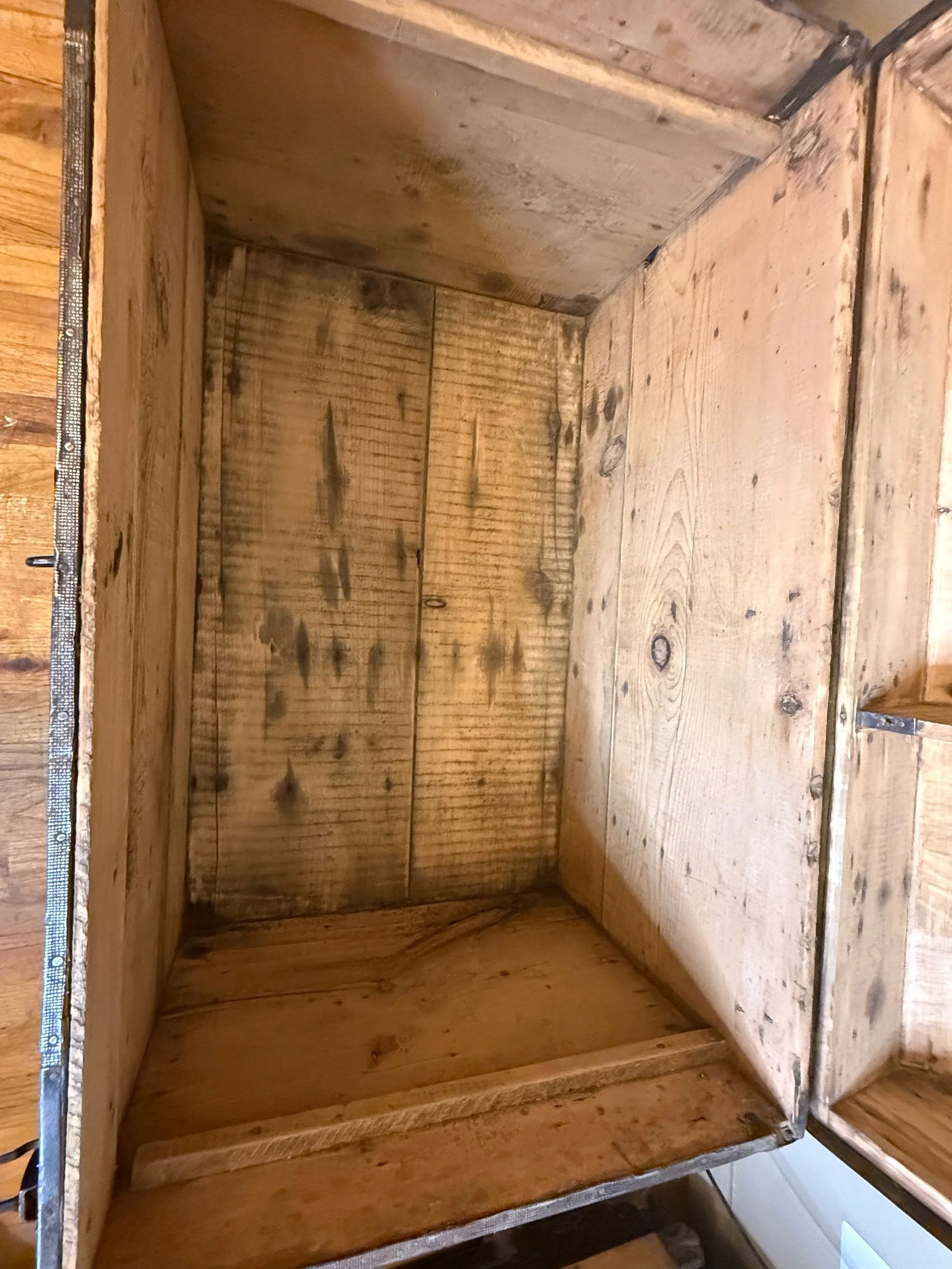 Natural wood interior inside antique storage chest