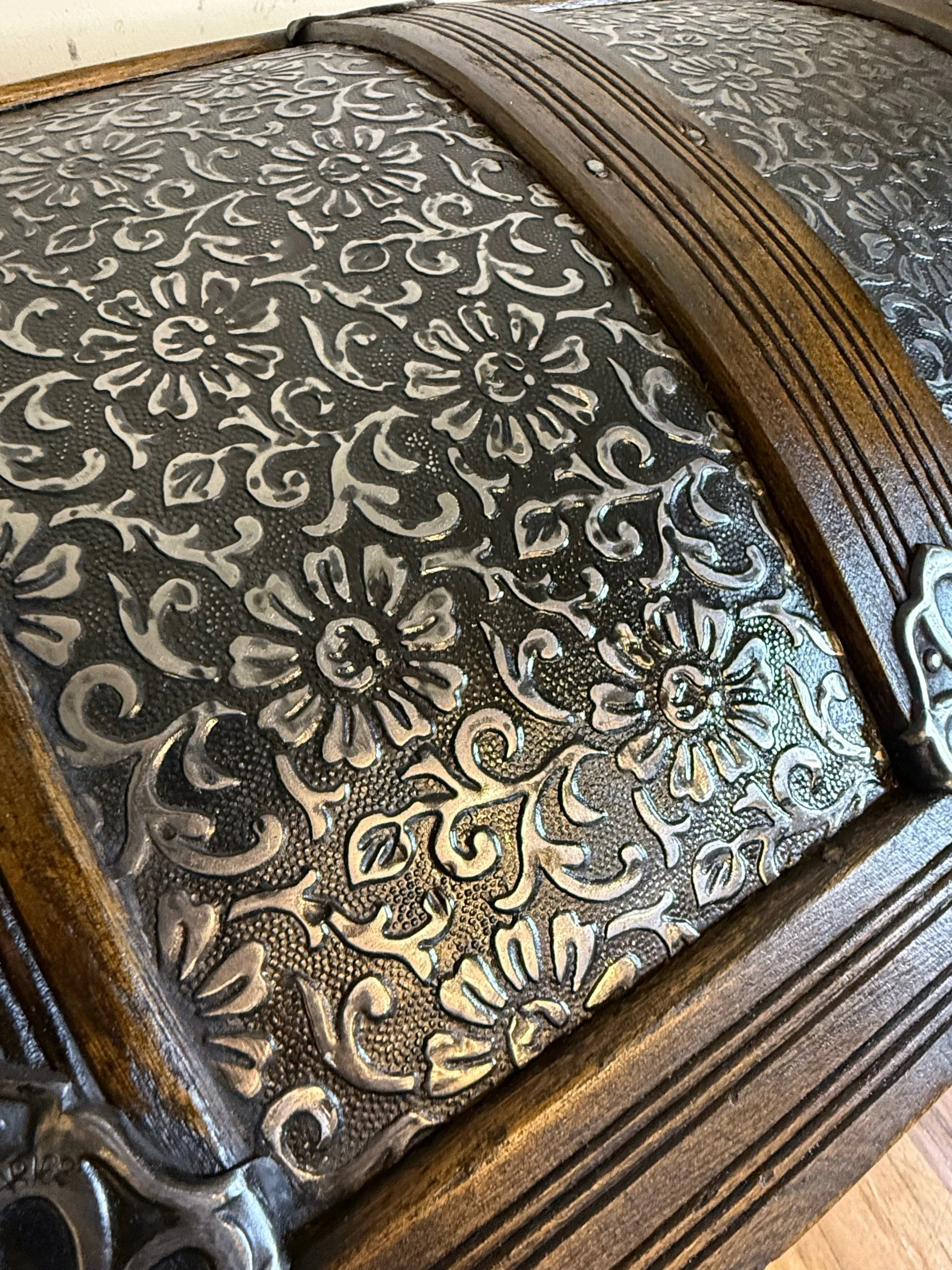 Sunflower and daisy pattern embossed tin on antique trunk