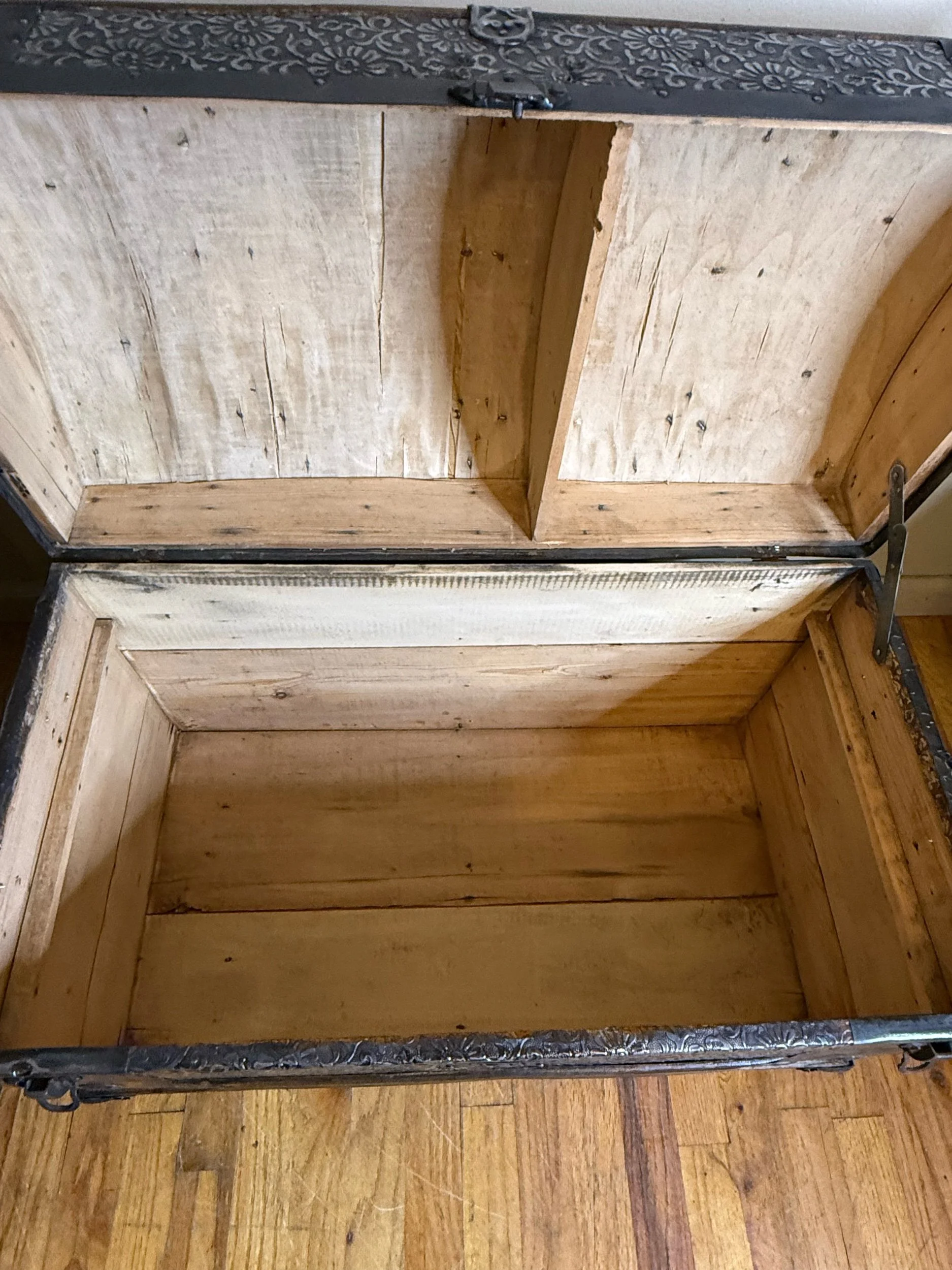Stripped and sanded wood interior of antique steamer trunk