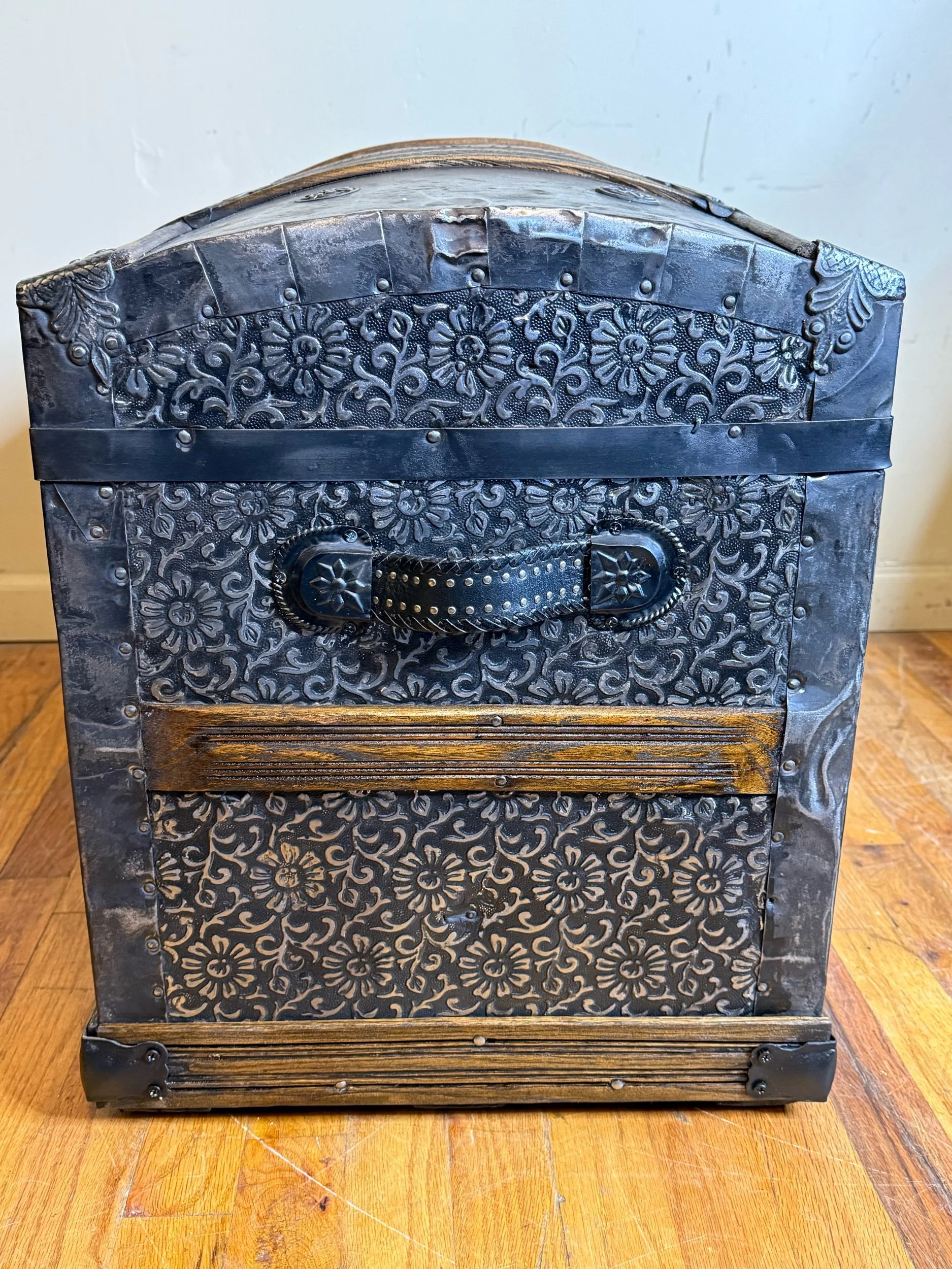Black studded leather handle on antique Saratoga trunk