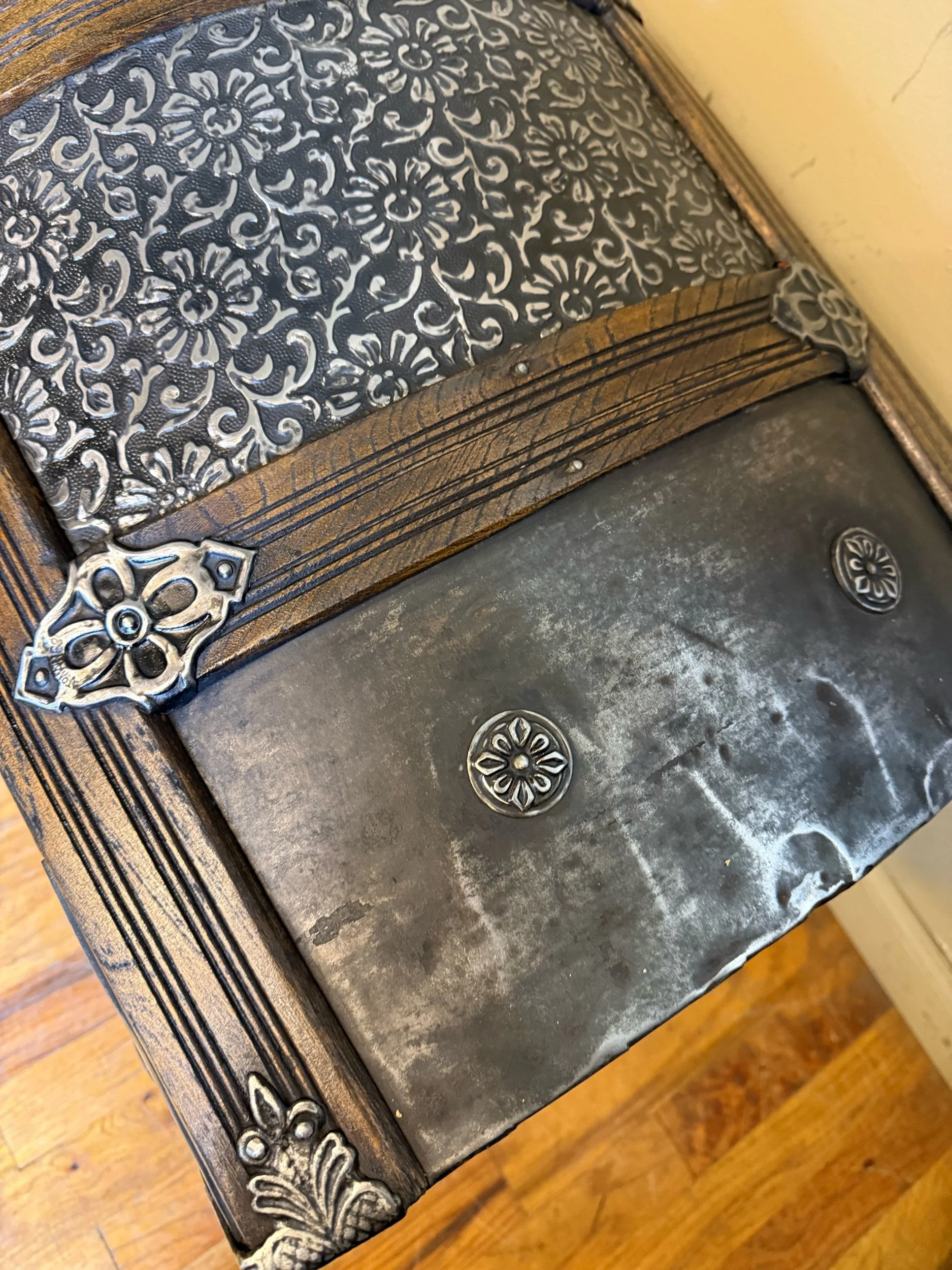 Close up of rare floral embossed tin Victorian trunk