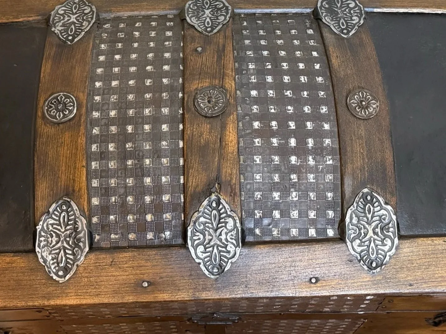 Victorian humpback trunk with embossed tin and ornate hardware
