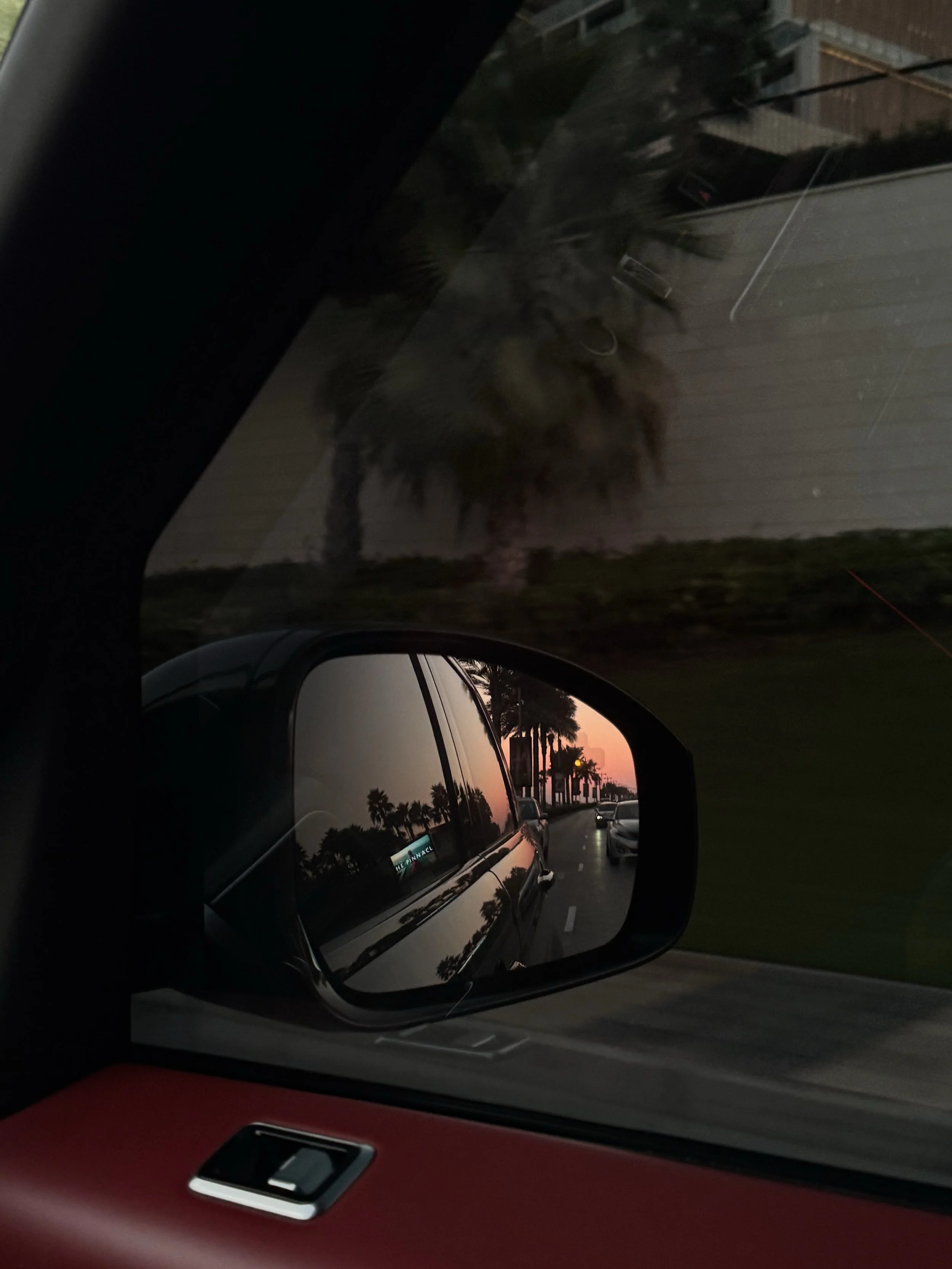 Red car drives along the coast to client location after learning of their packages from their optimized social media profile.