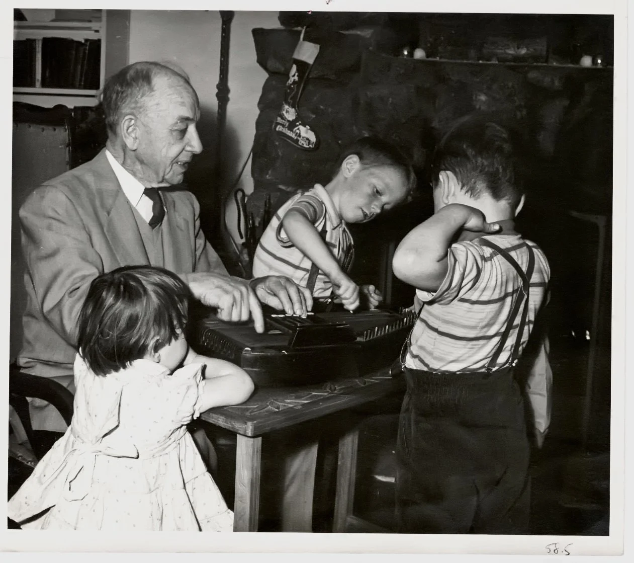 Andrew playing the autoharp with grandchildren 