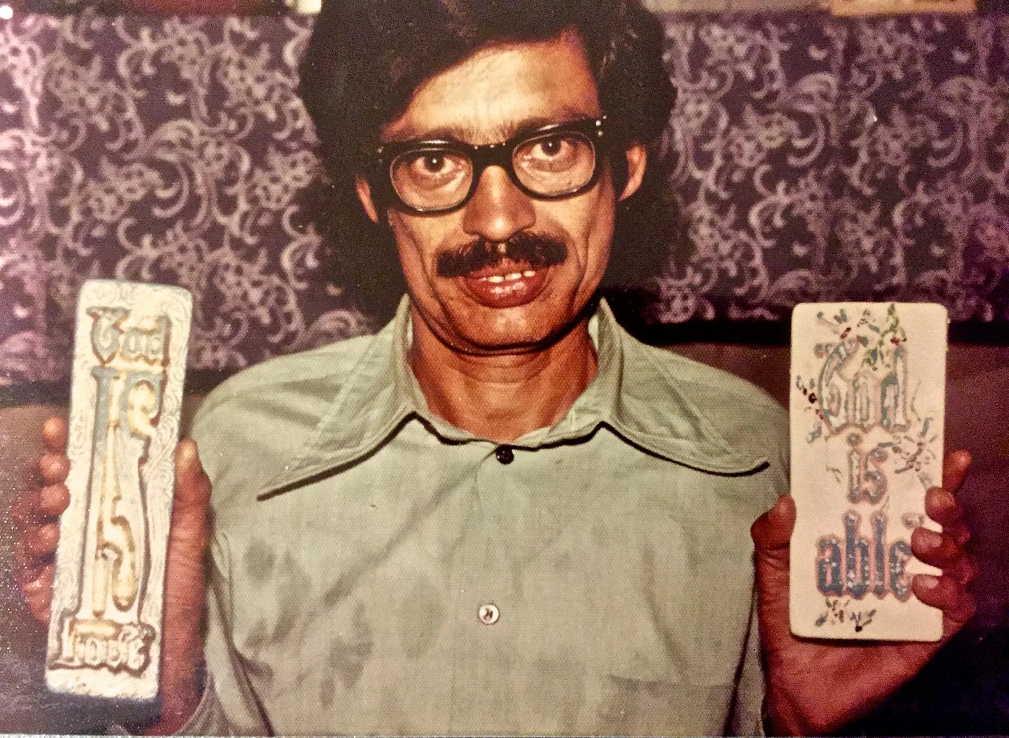 Man in Pakistan with two plaques