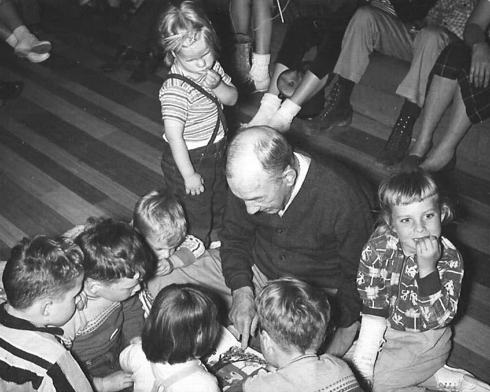 Andrew reading to the grandchildren at the family retreat, 1957