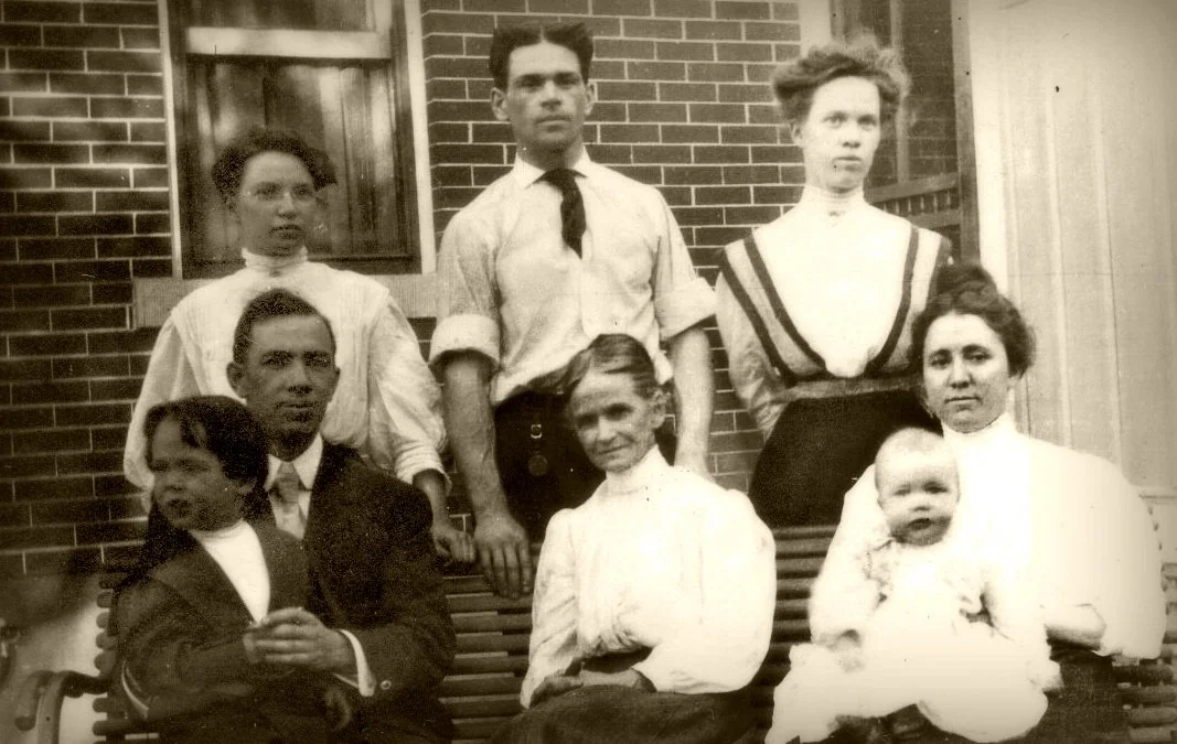 Andrew on the left holding Bryant and Sadie on the right holding Hubert in Colorado. Mary Mitchell is in the middle. Second row left: Eva, Loren and Suzanne, Andrew's siblings