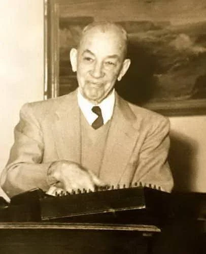 Andrew playing his autoharp in the Go-Ye Chapel on the family compound.