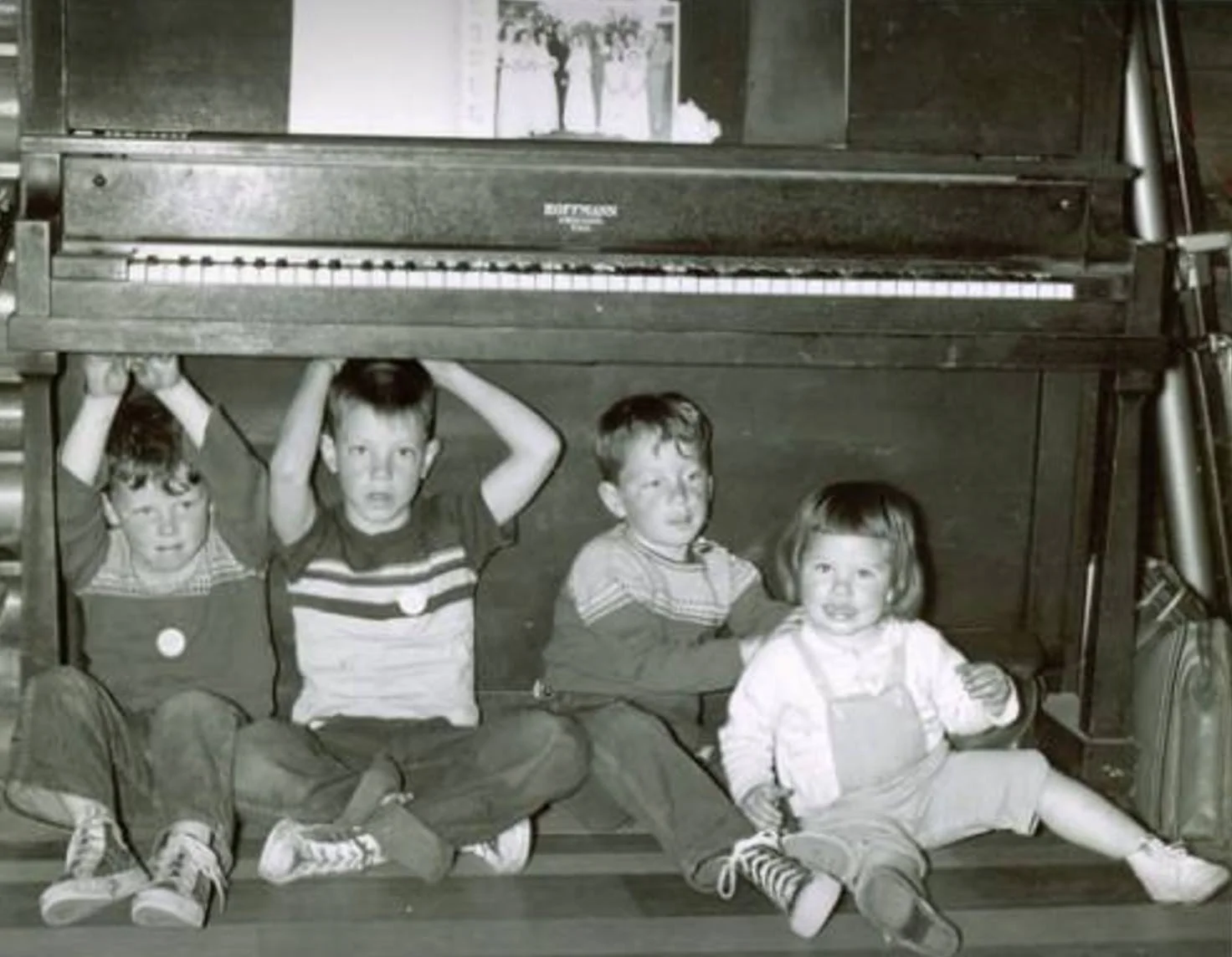 Grandchildren under the piano