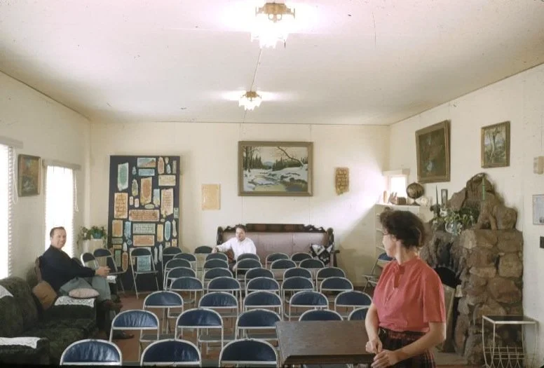 Andrew and Sadie's daughter Jean Wihelmsen in front, brother Hubert at left and her husband Kaare in back. There is a plaque embedded in the fireplace. Notice all of Andrew's plaques hanging in the back, and all the paintings are his. Go-Ye Fellowshi