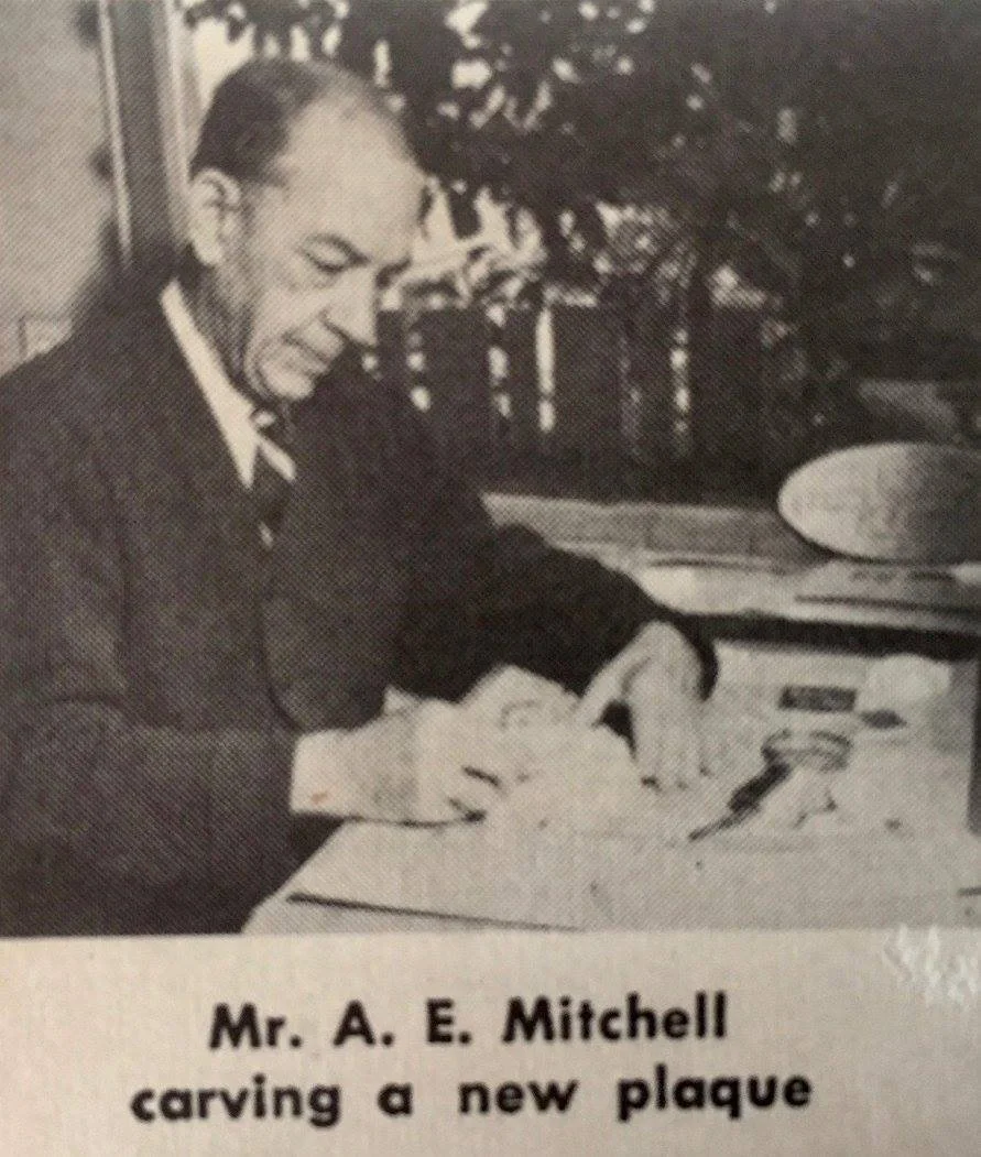 Andrew working on a plaque design - newspaper photo