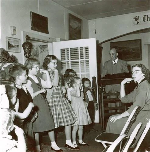 Esther Mitchell Russell leading children in the family in songs in the Go-Ye Prayer Garden chapel.