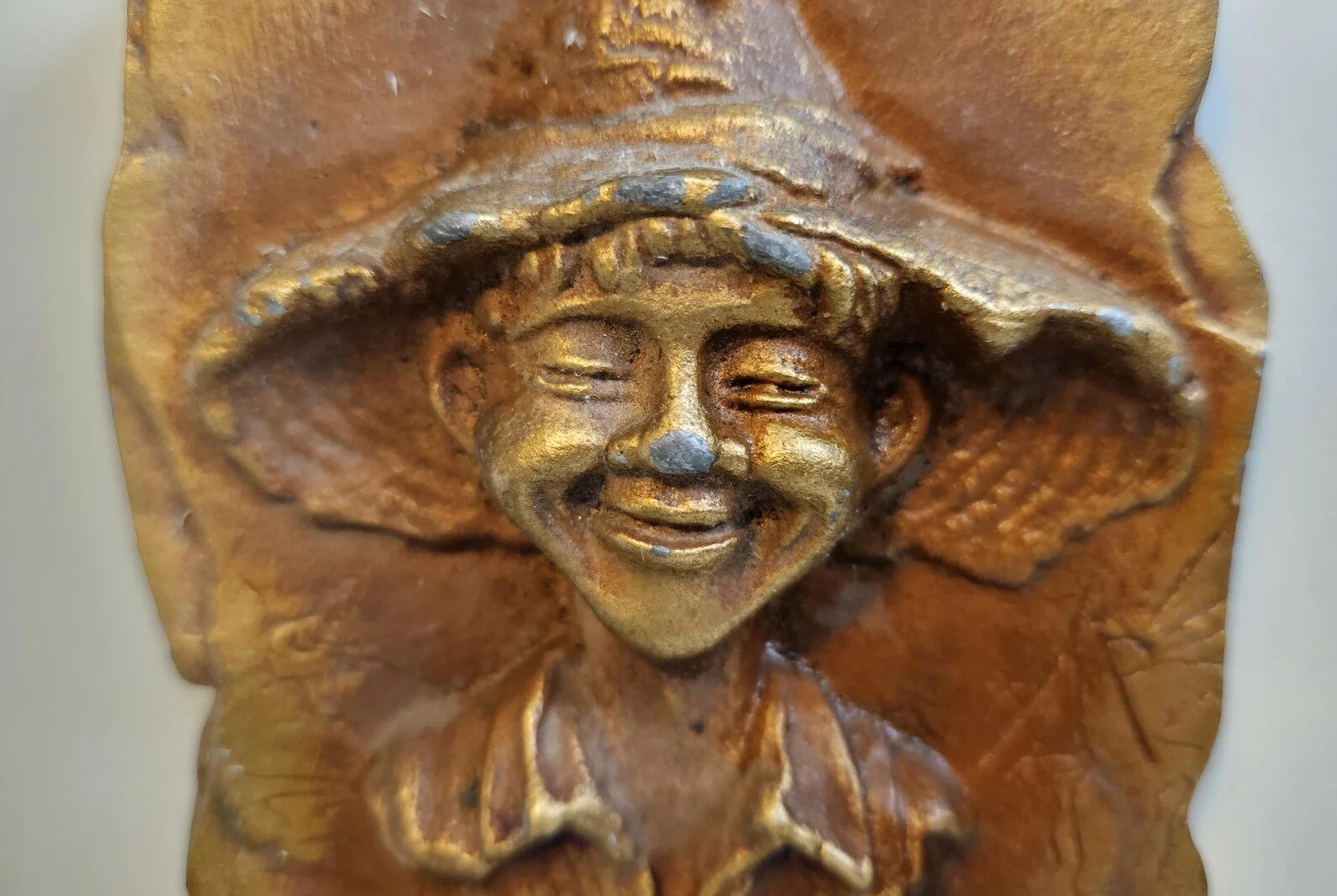 Detail of the boy's face on the "Me Worry?" plaque