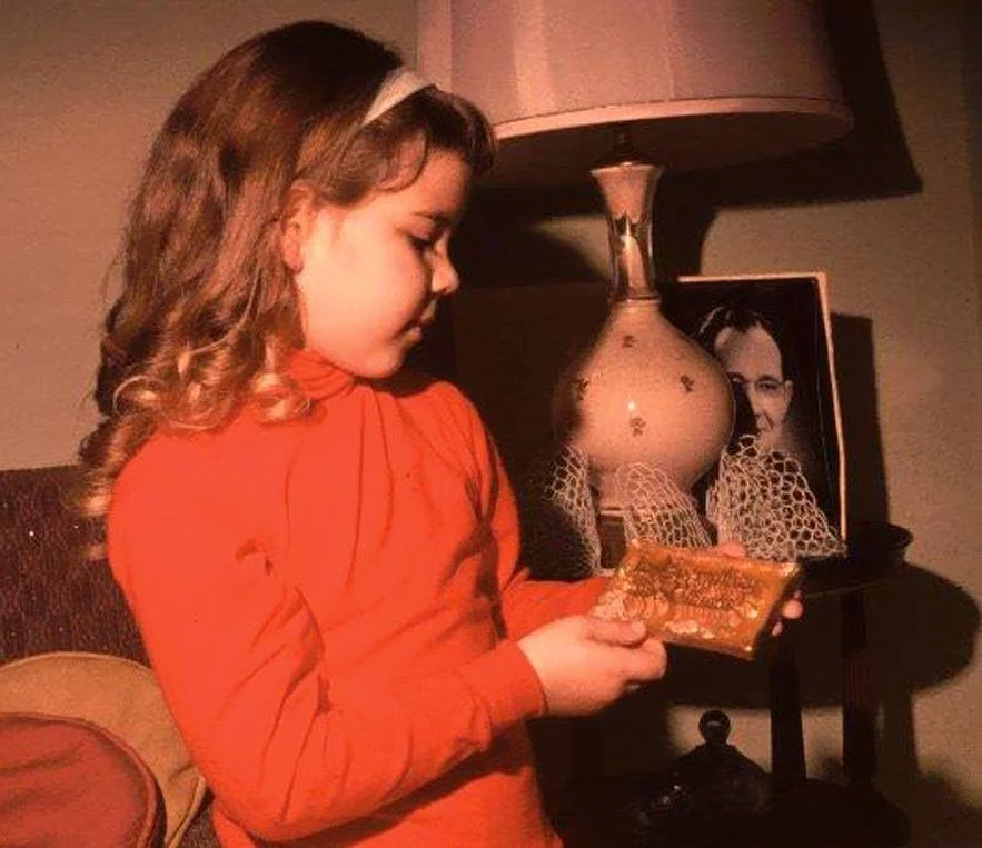 Great-Granddaughter Lori Warner holding a favorite plaque in the late 1960s.