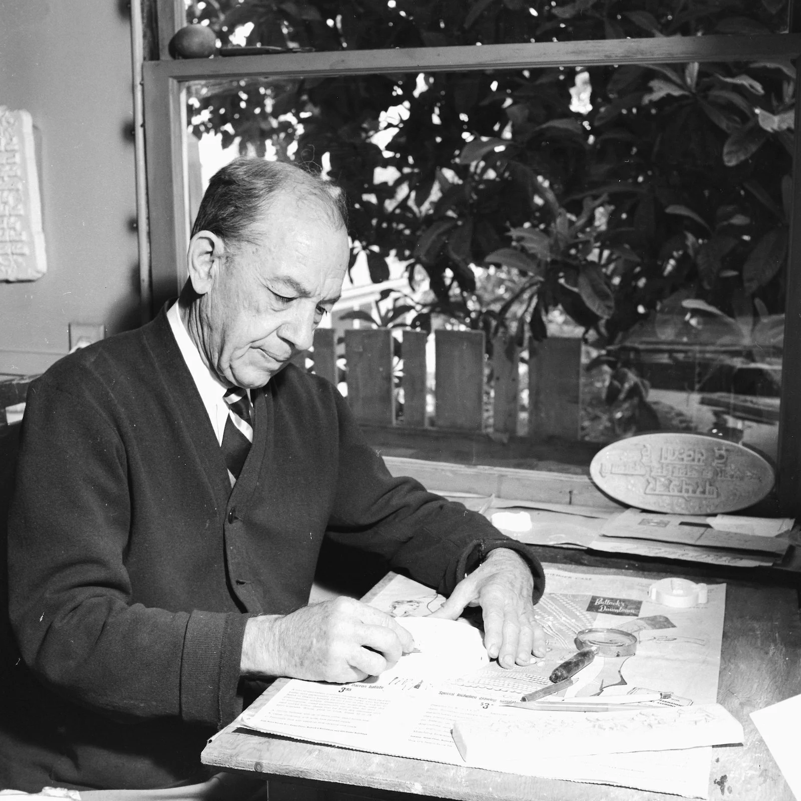 Andrew carving a plaque. Photo used for newspaper article. 