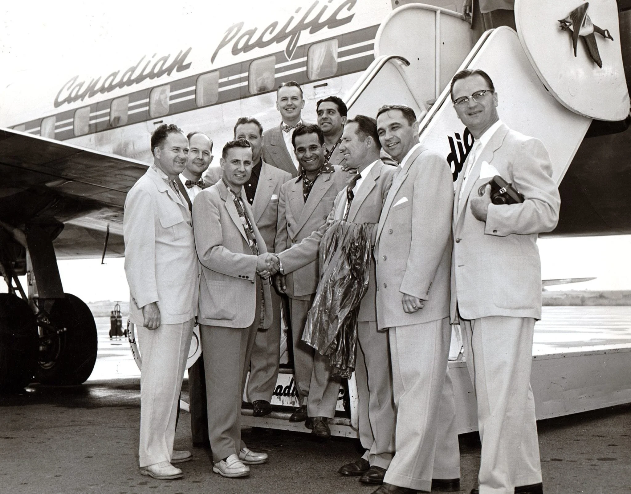 Youth for Christ group - Hubert Mitchell in the middle shaking hands with gentleman. 