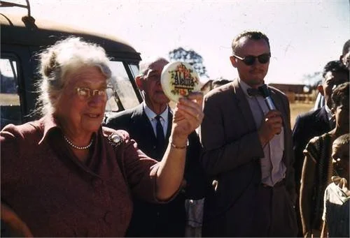 Jennie holding up one of Andrew's plaques and speaking to people in Belo Horizonte. 